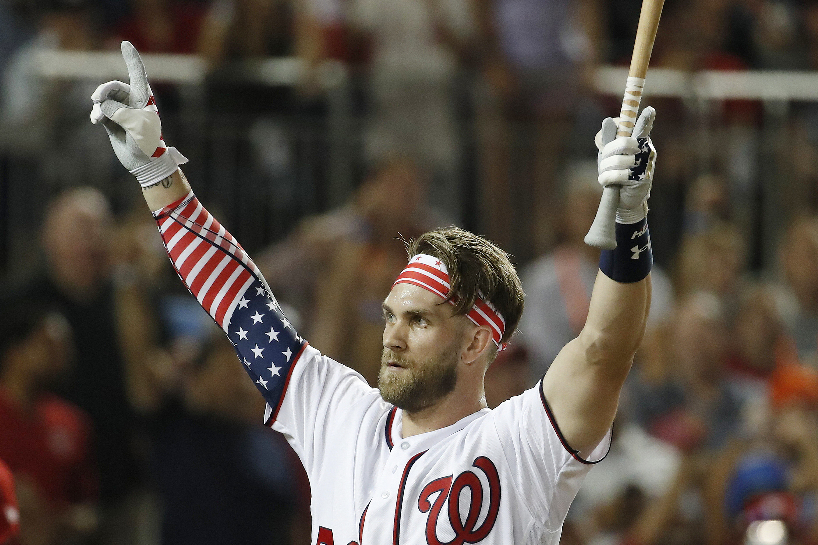 A Washington Nationals fan wears a Bryce Harper jersey in the