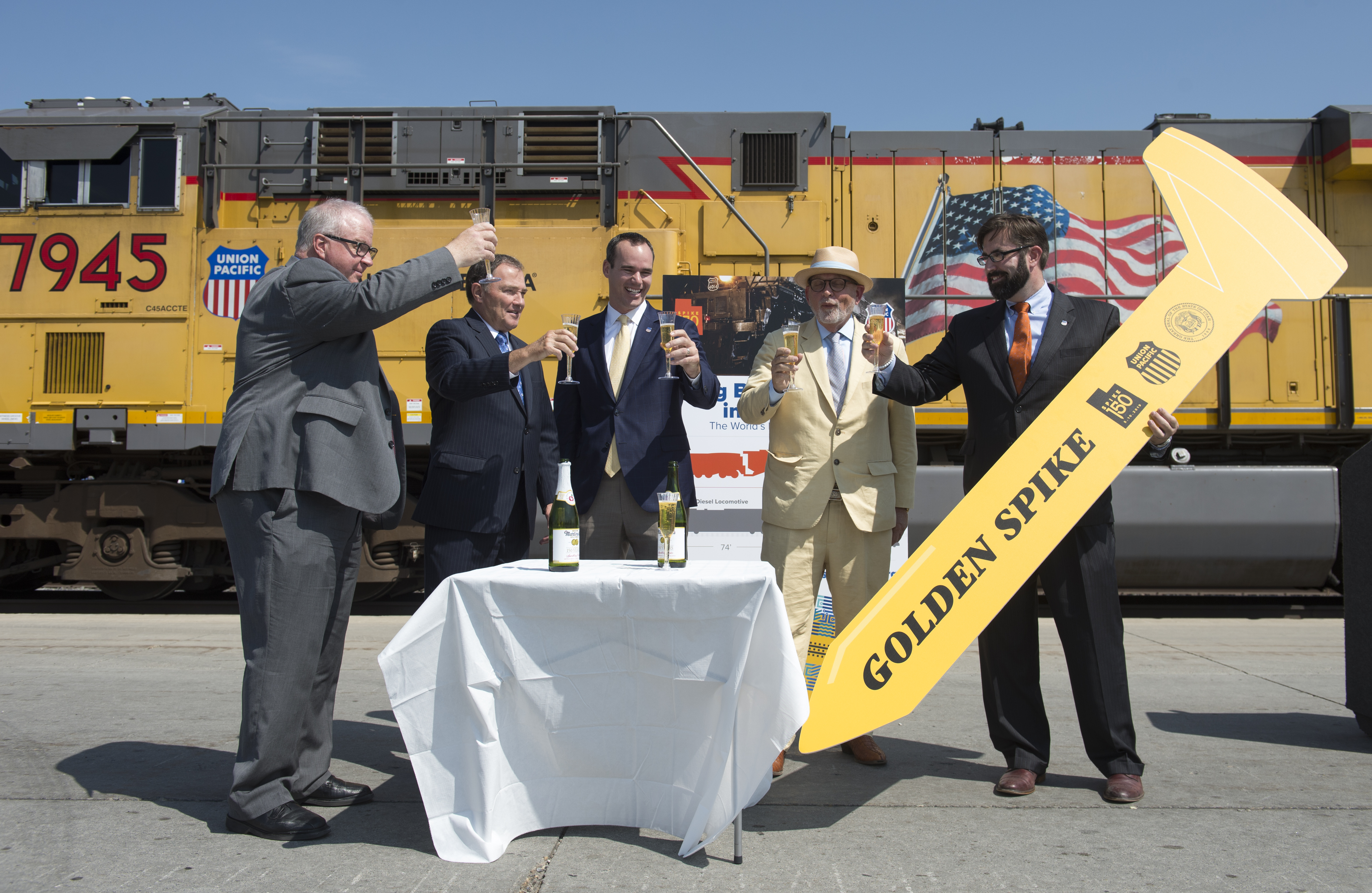 (Rick Egan | The Salt Lake Tribune) Left to right Historian Brad Westwood, Gov. Gary Herbert, Clint Schelbitski Union Pacific Vice-President, Public Affairs, Doug Foxley, Spike 150 Celebration co-chair, and Nathan Anderson, Union Pacific director of public relations have a toast as they announce the 150 anniversary celebration of the Golden Spike, at the Union Pacific Intermodal Facility, Thursday, Aug. 16, 2018. 