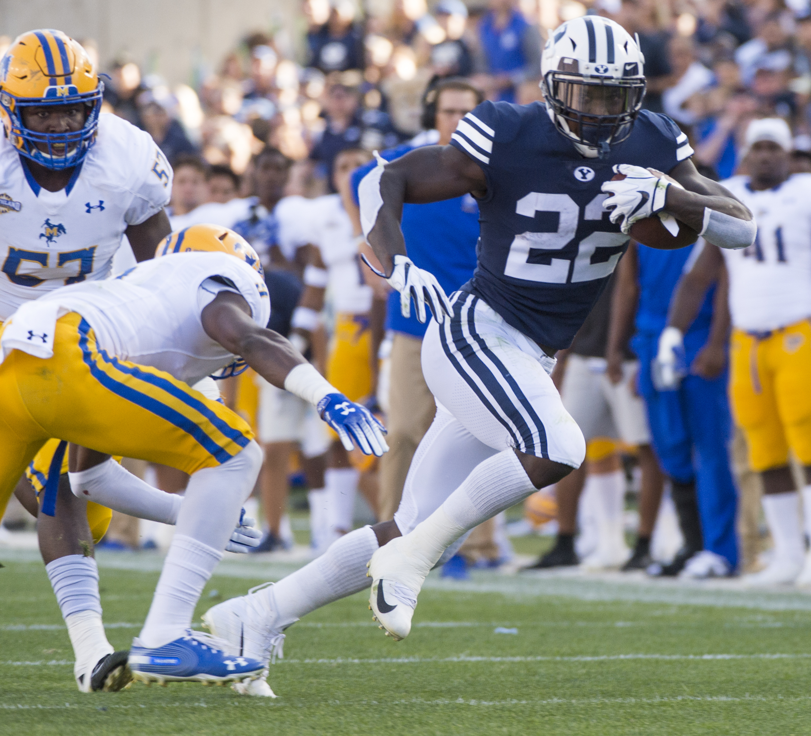 (Rick Egan | The Salt Lake Tribune) Brigham Young Cougars running back Squally Canada (22) gets past McNeese State Cowboys defensive lineman Cody Roscoe (57) and McNeese State Cowboys defensive back Trent Jackson (9), in football action Brigham Young Cougars vs McNeese State Cowboys at Lavell Edwards Stadium, Saturday, Sept. 22, 2018. 