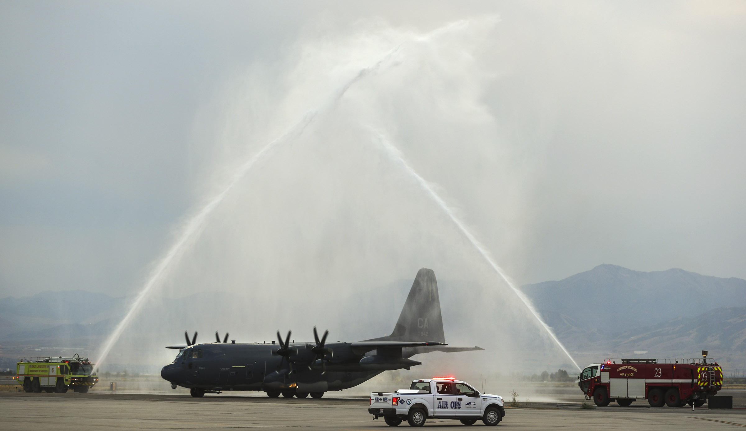 (Steve Griffin | Deseret News, pool photo) A C130-J carrying the casket of Draper Battalion Chief Matt Burchett taxis through a water arch as it lands at the Utah Air National Guard Base in Salt Lake City on Wednesday, Aug. 15, 2018. Burchett was killed while fighting the Mendocino Complex Fire north of San Francisco.