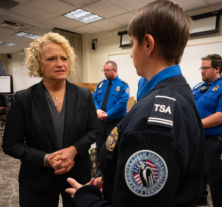 (Trent Nelson | The Salt Lake Tribune) Salt Lake City Mayor Jackie Biskupski speaks to TSA employee Woodrina Berg. Biskupski had pizza delivered to TSA and other federal employees to thank them for working at the airport without pay during the partial federal shutdown on Tuesday Jan. 22, 2019. Food from the Utah Food Pantry was stacked around the training room to cover the needs of employees.