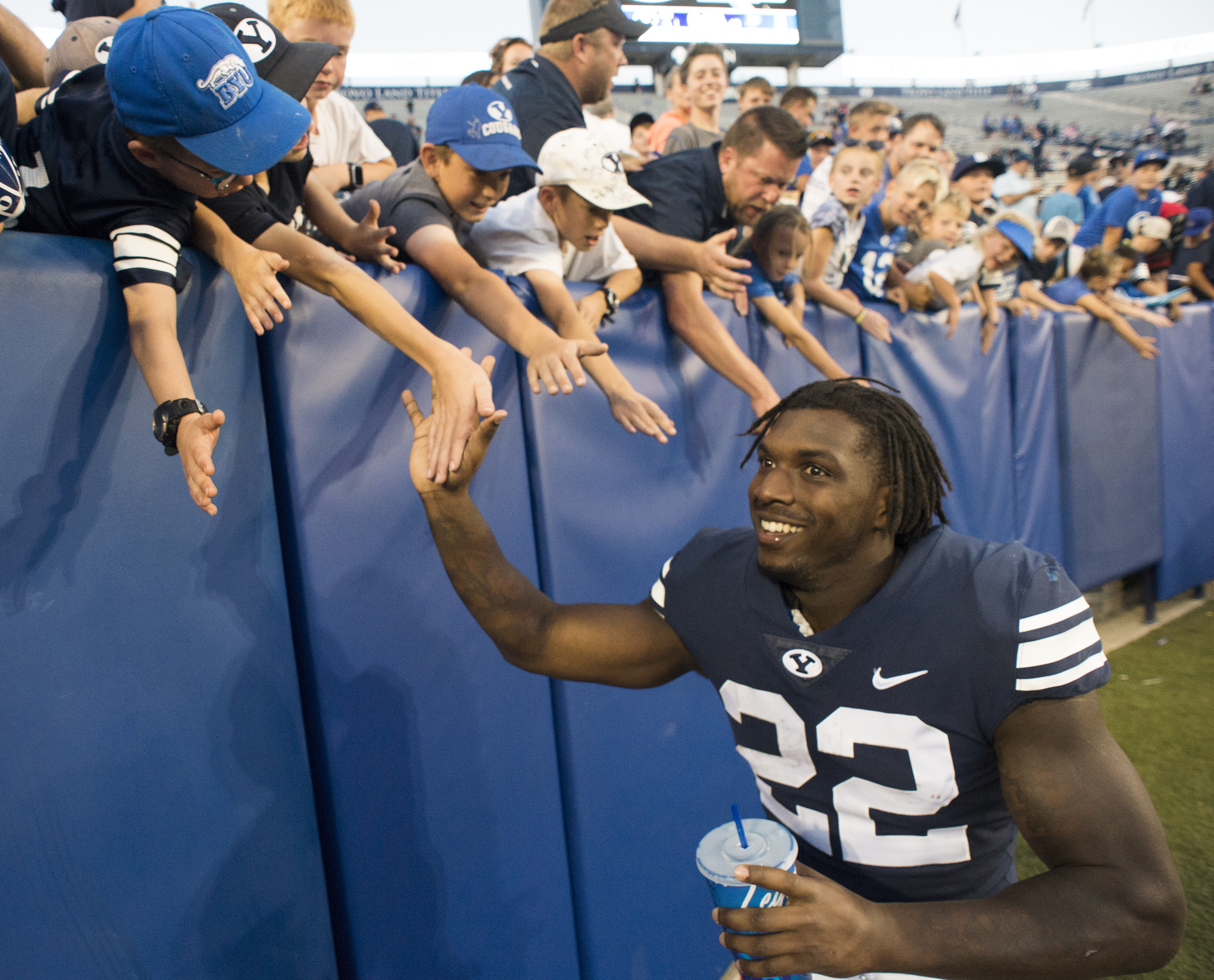(Rick Egan | The Salt Lake Tribune) Brigham Young Cougars running back Squally Canada (22) high-fives the crowd after the Brigham Young Cougars defeated the McNeese State Cowboys 30-3, at Lavell Edwards Stadium, Saturday, Sept. 22, 2018. 