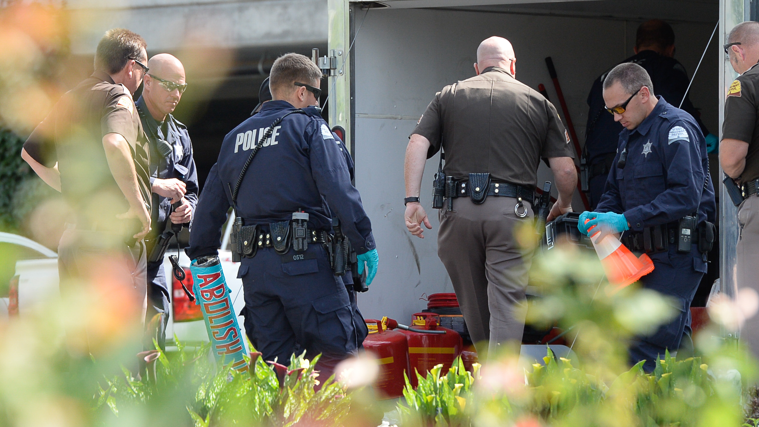 (Francisco Kjolseth | The Salt Lake Tribune) Police gather evidence, including arm lock tubes with the words "ABOLISH ICE" after activists staged a protest against a private prison company with contracts to hold undocumented immigrants on Thursday, July 12, 2018, at the headquarters of Management and Training Corporation in Centerville.