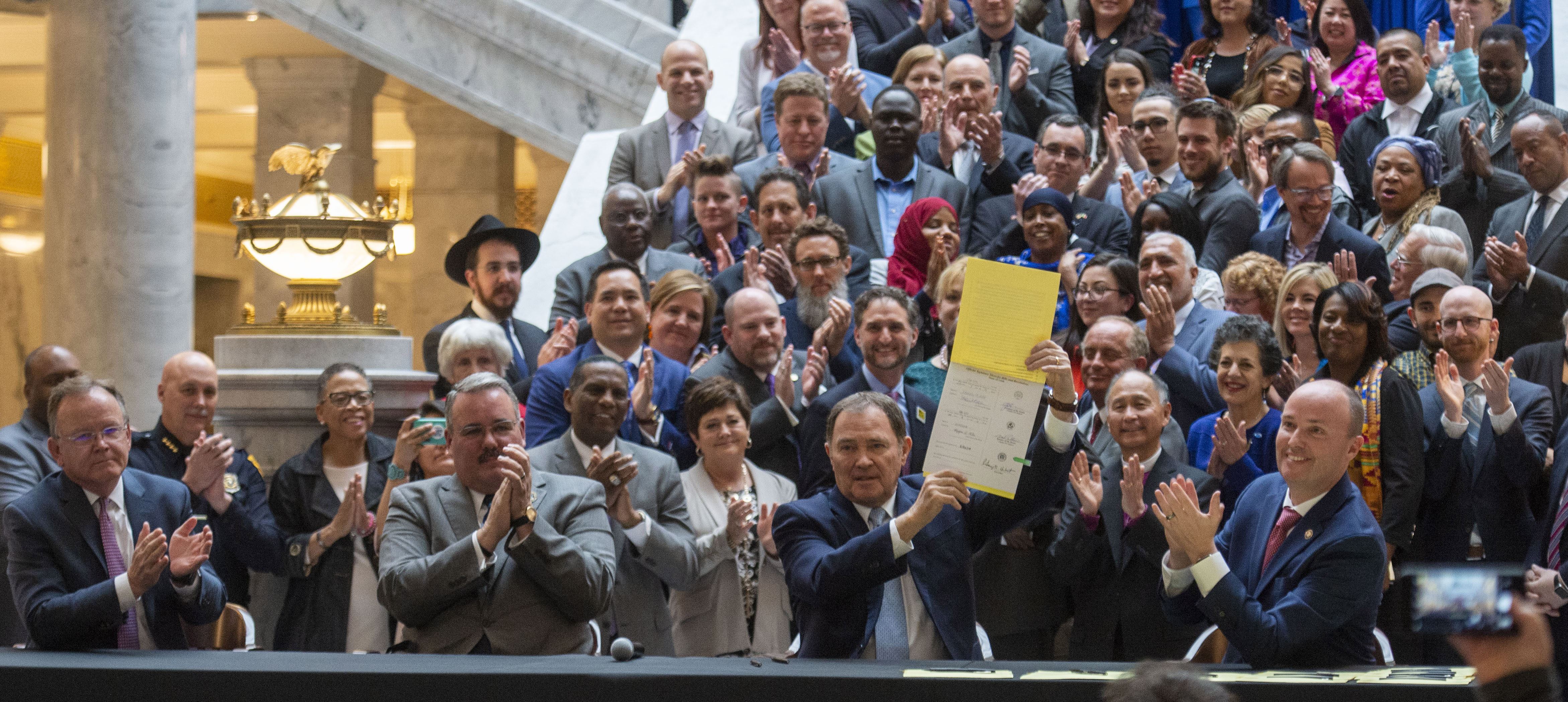 (Rick Egan | The Salt Lake Tribune) Surrounded by supporters, Gov. Gary R. Herbert signs into law the new hate crimes bill along with Senate President Stuart Adams, Sen. Daniel Thatcher, Rep. Lee Perry and Lt Gov. Spencer Cox, at the Utah State Capitol, Tuesday, April 2, 2019. 