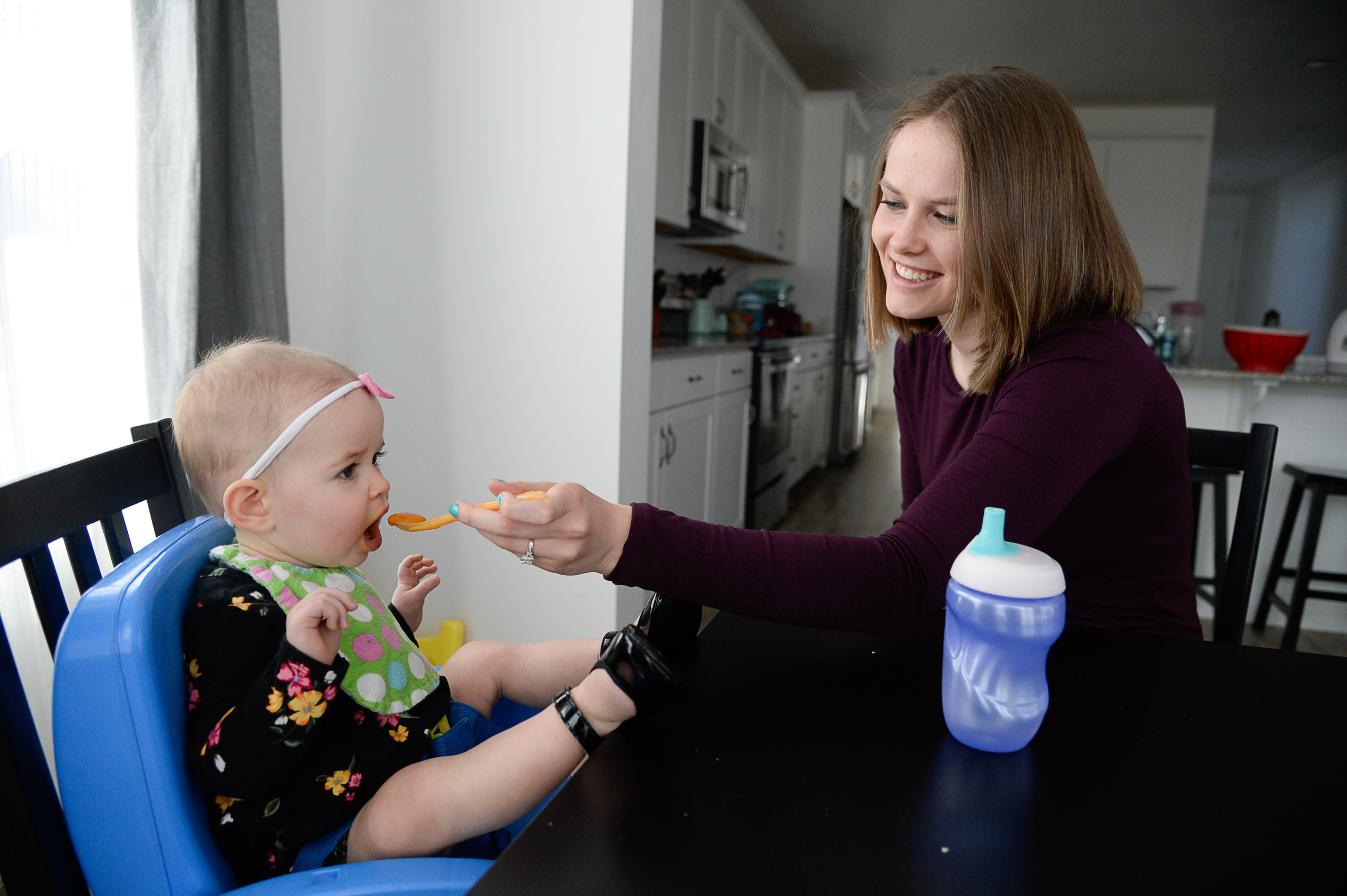 (Francisco Kjolseth | The Salt Lake Tribune) Ember Ulrich feeds her daughter Jemma, 1, at their home in Lehi during the lunch hour. Ember and her husband Jeremy moved in last October from from Pleasant Grove because they could get more house for their money there, and it's closer to Jeremy's job at Adobe in Lehi.