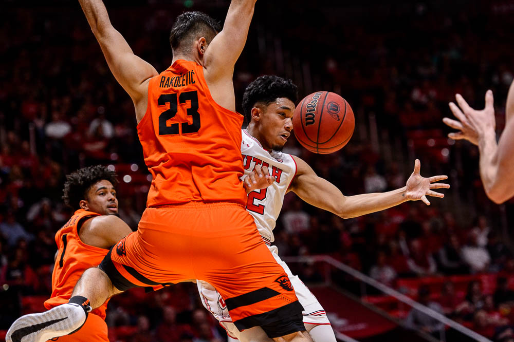 (Trent Nelson | The Salt Lake Tribune) Utah Utes guard Sedrick Barefield (2) drives around Oregon State Beavers center Gligorije Rakocevic (23) as Utah hosts Oregon State, NCAA basketball in Salt Lake City on Saturday Feb. 2, 2019. At left is Oregon State Beavers guard Stephen Thompson Jr. (1).