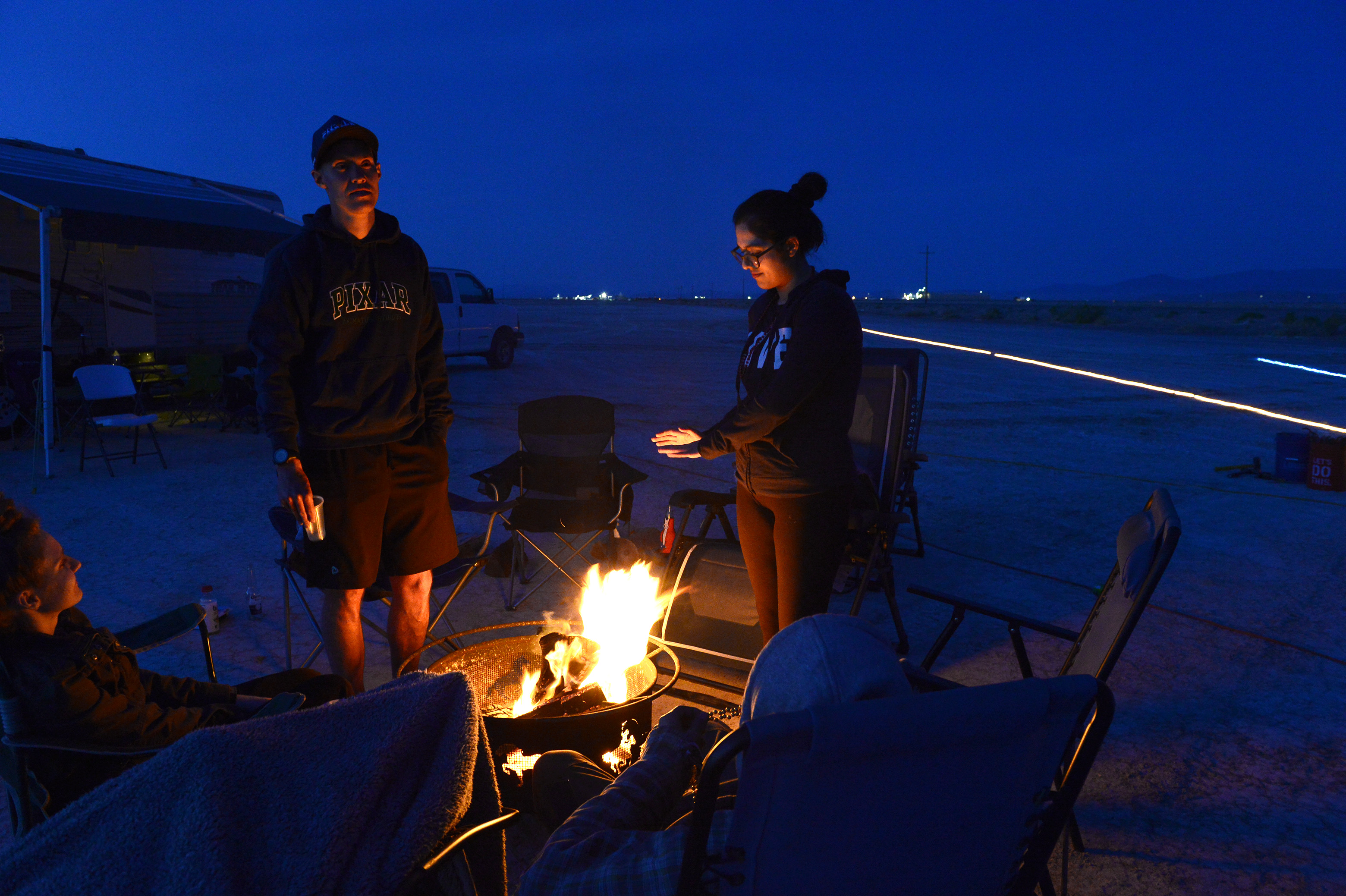 (Scott Sommerdorf | The Salt Lake Tribune) Volunteers at Aid Station 14 warm themselves around a fire at the Salt Flats 100 Endurance Run, Saturday, May 5, 2018. 