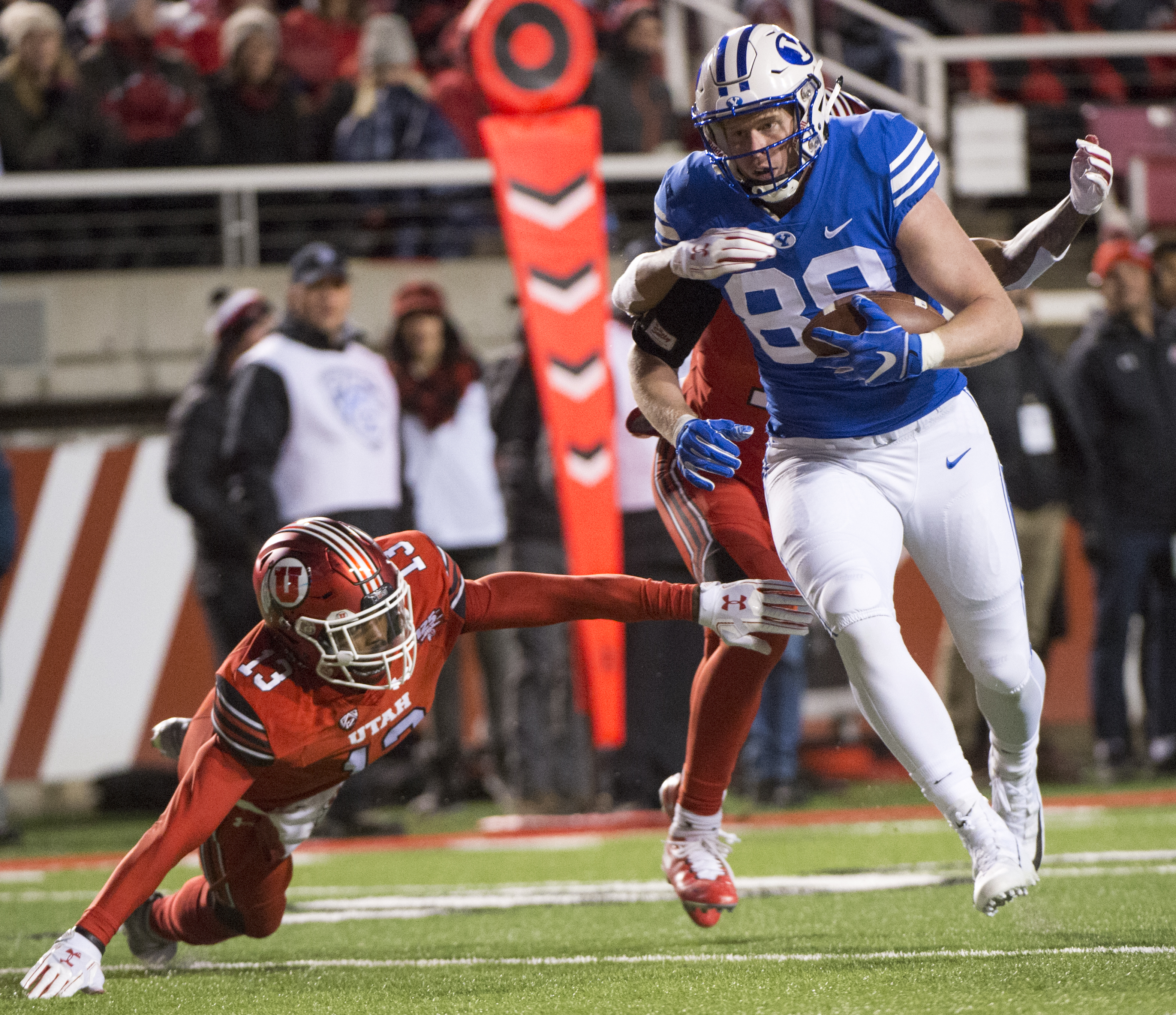 (Rick Egan | The Salt Lake Tribune) Brigham Young Cougars tight end Matt Bushman (89) gets past Utah Utes defensive back Marquise Blair (13) and Utah Utes defensive back Corrion Ballard (15) to score a touchdown for the Cougars, in football action between the Brigham Young Cougars and the Utah Utes, at Rice-Eccles Stadium, Saturday, November 24, 2018. 