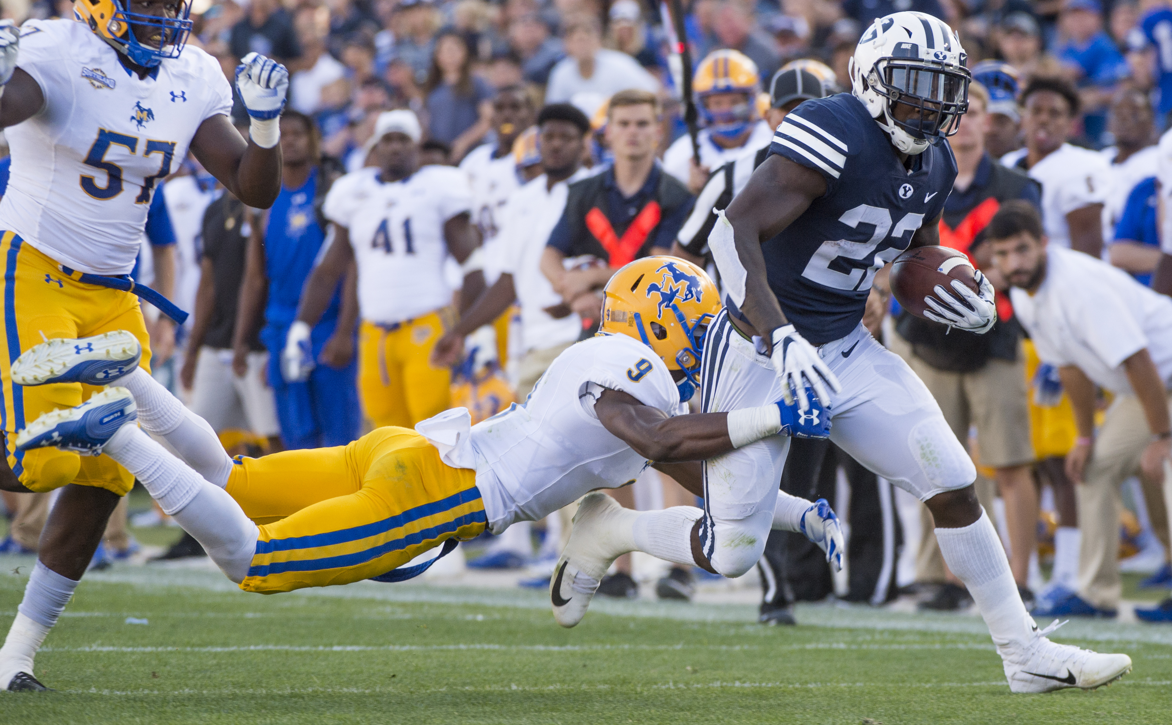 (Rick Egan | The Salt Lake Tribune) Brigham Young Cougars running back Squally Canada (22) gets past McNeese State Cowboys defensive lineman Cody Roscoe (57) and McNeese State Cowboys defensive back Trent Jackson (9), in football action Brigham Young Cougars vs McNeese State Cowboys at Lavell Edwards Stadium, Saturday, Sept. 22, 2018. 