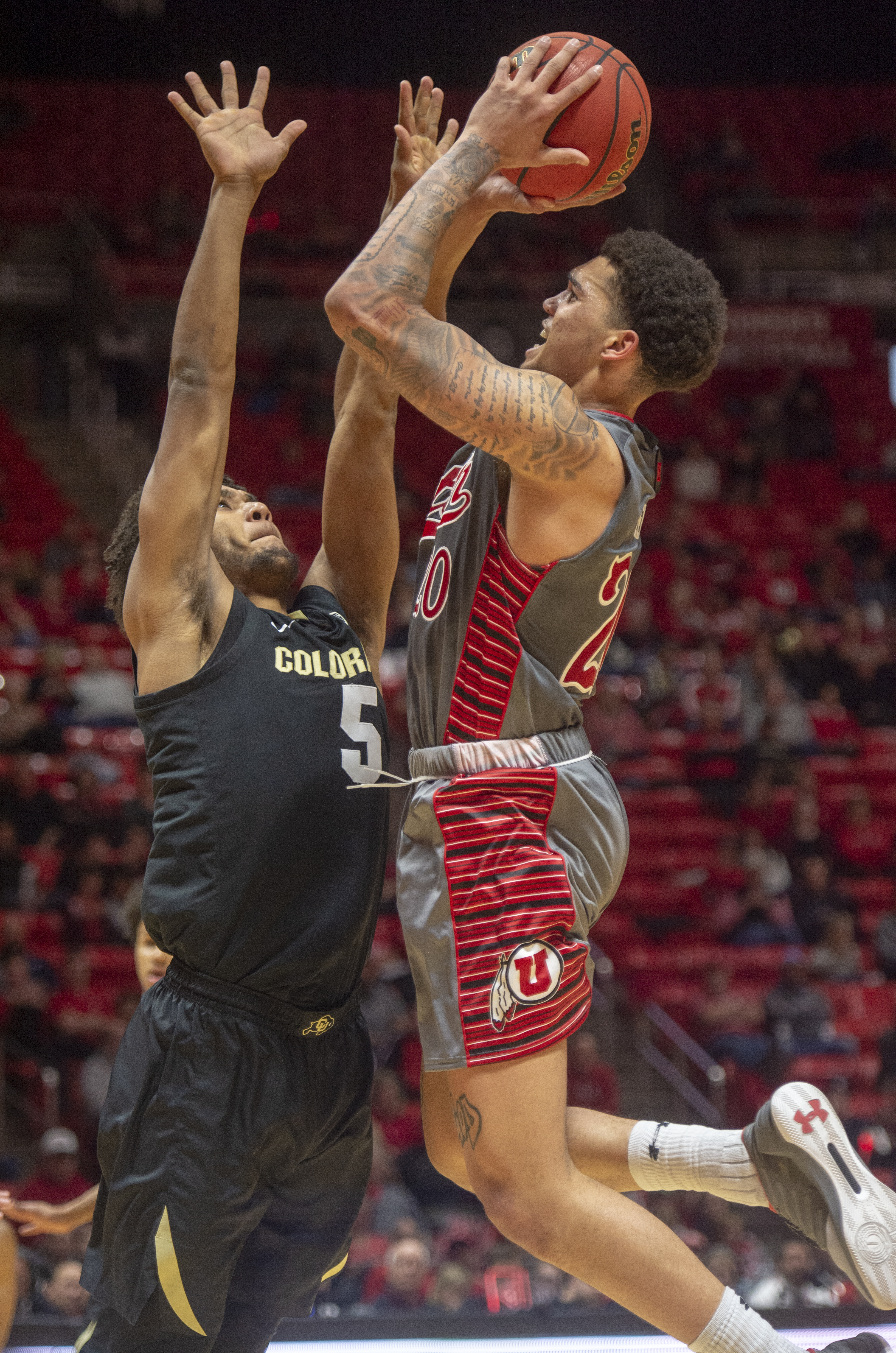 (Rick Egan | The Salt Lake Tribune) Utah Utes forward Timmy Allen (20) shoots as Colorado Buffaloes guard D'Shawn Schwartz (5) defends, in PAC-12 basketball action between the Utah Utes and the Colorado Buffaloes at the Jon M. Huntsman Center, Sunday, Jan. 20, 2019. 