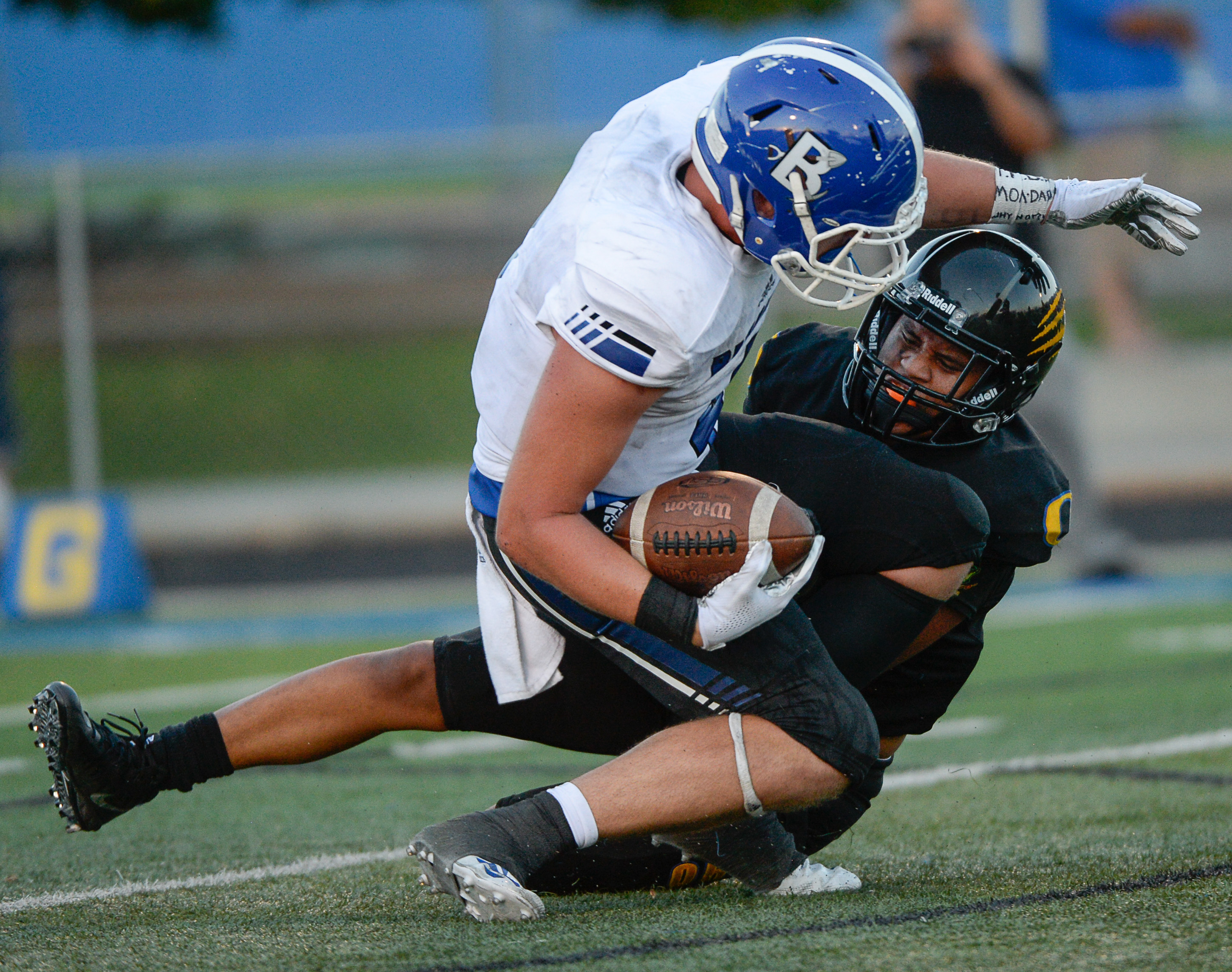 (Francisco Kjolseth | The Salt Lake Tribune) Bingham's Briasen Harward is taken down by Orem's Buju Tuisavura in the first half of the game, Thursday, Aug. 16, 2018 in Orem.