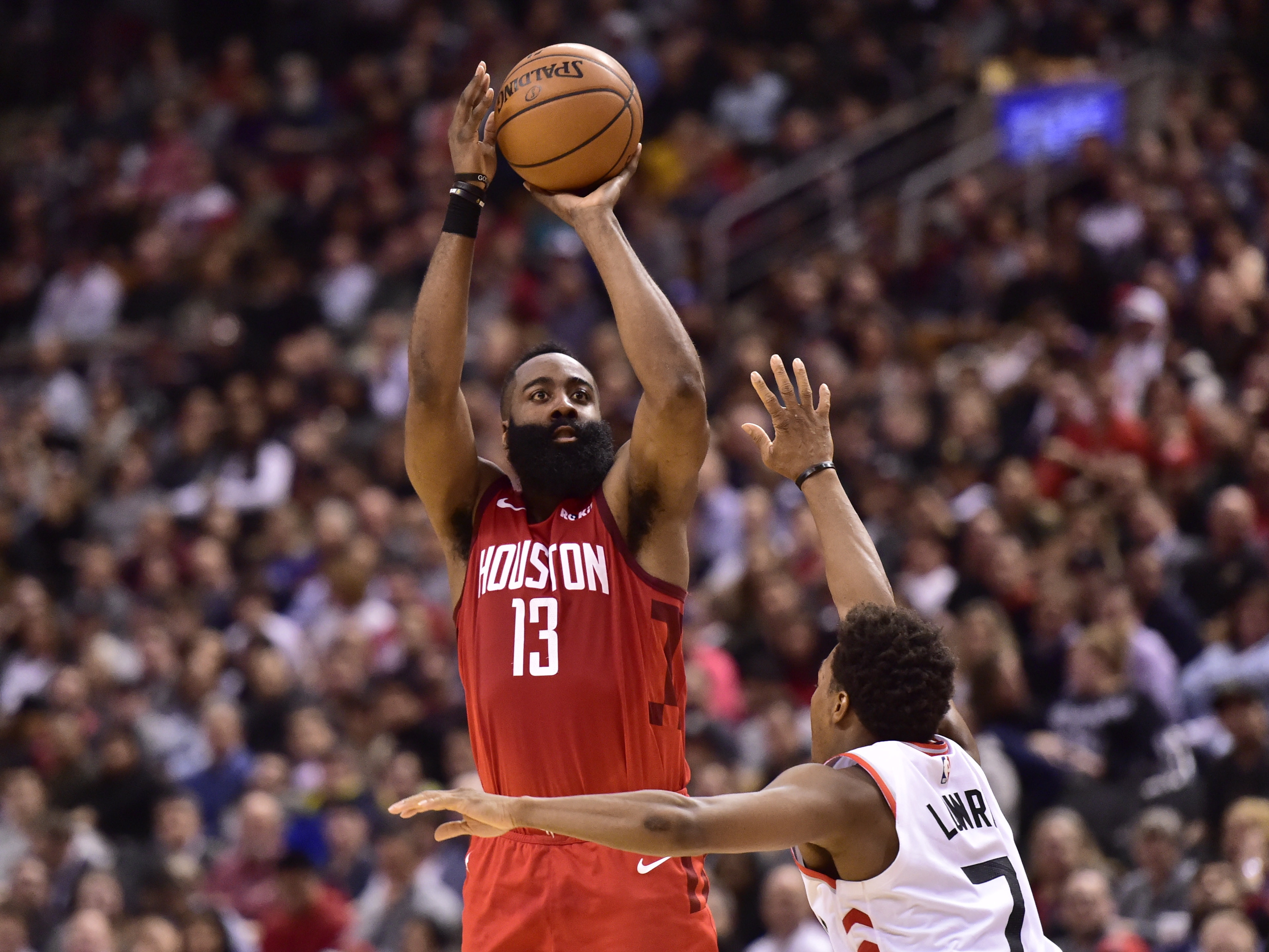 Houston Rockets guard James Harden (13) shoots over Toronto Raptors guard Kyle Lowry (7) during the second half of an NBA basketball game Tuesday, March 5, 2019, in Toronto. (Frank Gunn/The Canadian Press via AP)