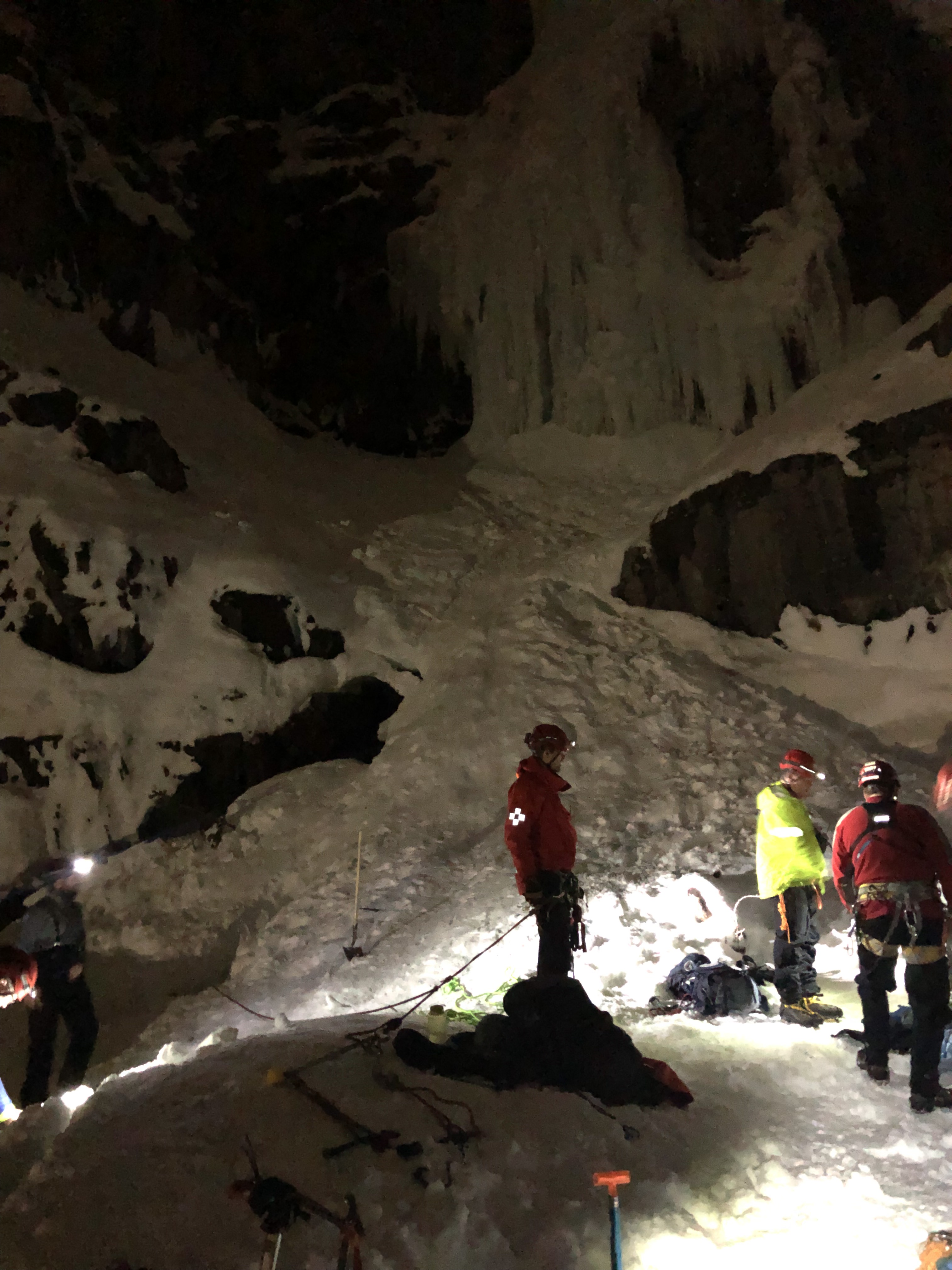 (Photo courtesy of the Utah County Sheriff's Office) Rescuers help a dog that fell into a 40-foot snow cavern at Stewart Falls near Sundance Ski Resort. The dog, Beeroo, fell through a hole in the ceiling on Saturday, Feb. 2.