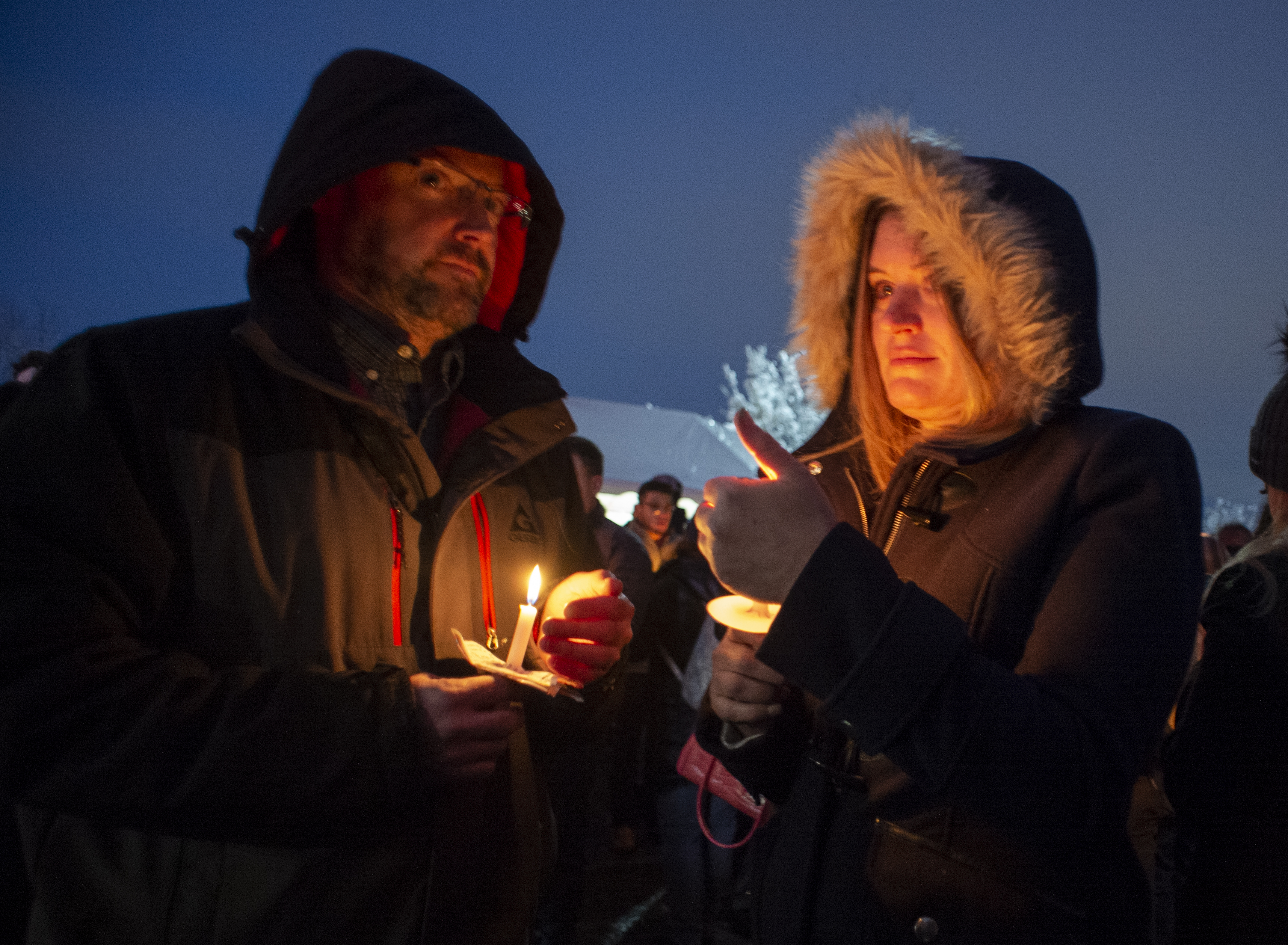 (Rick Egan | The Salt Lake Tribune) Tim and Kim McCann, from Alpine, hold candles during a candlelight vigil for David Stokoe, a real estate agent killed at one of his rentals last week. Monday, Jan. 21, 2019.