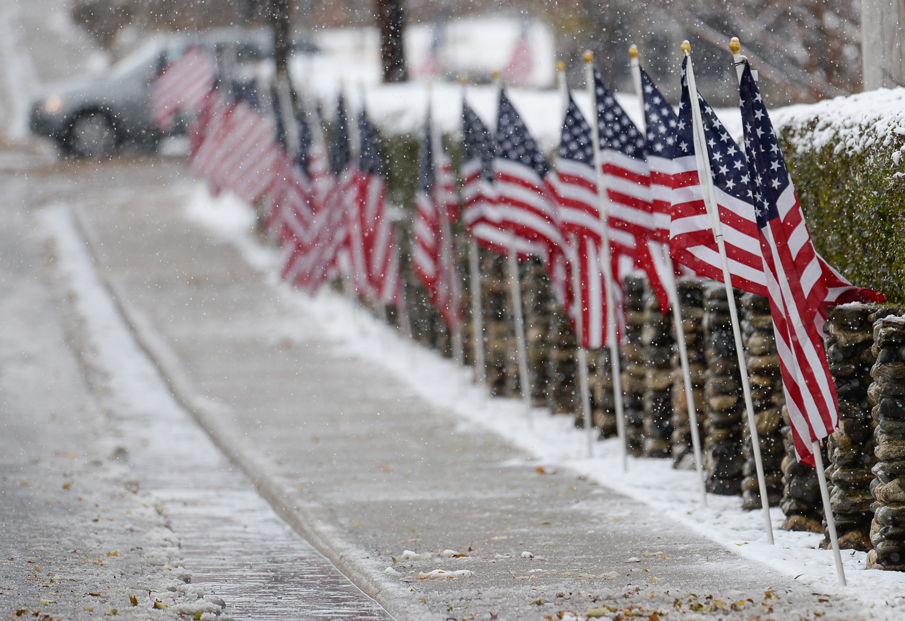 (Francisco Kjolseth | The Salt Lake Tribune) U.S. flags line the street next to Farmington City Cemetery in honor of former congressman Jim Hansen being laid to rest in Farmington, Saturday, Nov. 24, 2018.