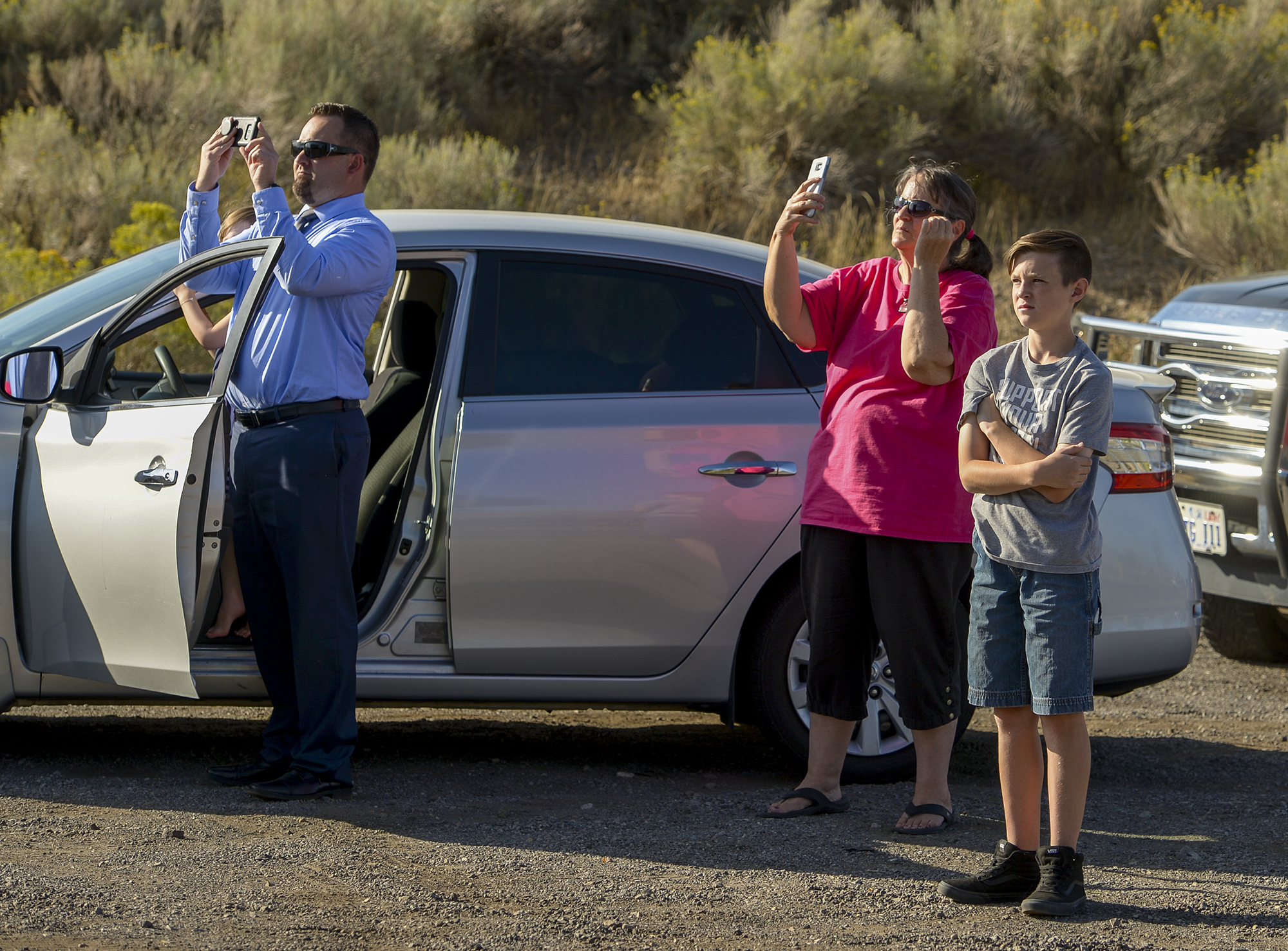 Leah Hogsten | The Salt Lake Tribune Homeowners who were not allowed to return to their homes and onlookers waited near Herriman Cove pond and park. A 50-acre wildfire in Rose Canyon was threatened about a half-dozen homes Wednesday, Sept. 12, 2018. A spokesman for Unified Fire said the blaze has already burned a few structures, including outhouses and sheds. Firefighters have evacuated around 20 to 30 homes in two neighborhoods near 15555 S. Rose Canyon Road in Herriman. 