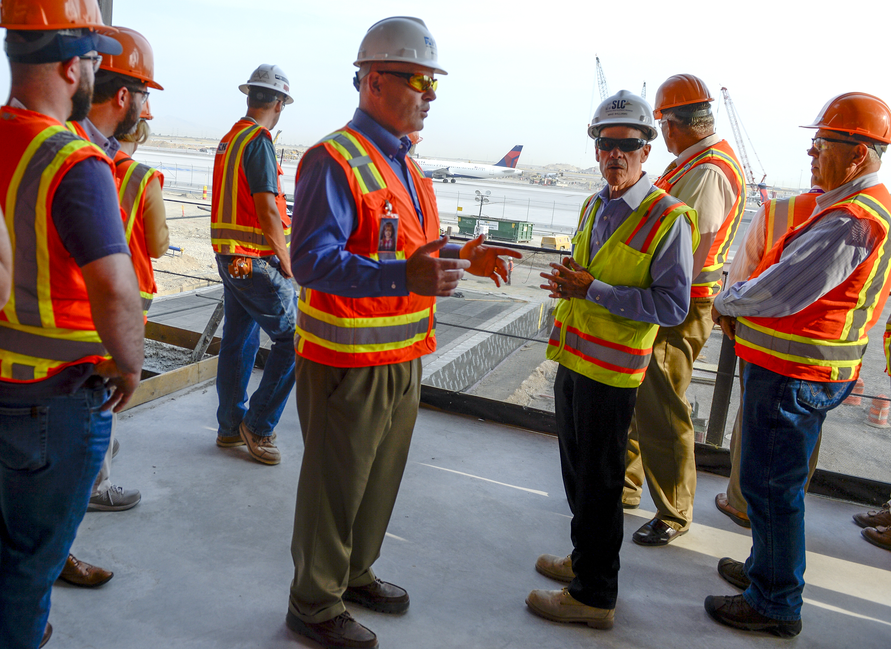 Leah Hogsten | The Salt Lake Tribune l-r Salt Lake City International Airport construction manager Leon Nelson and project manager Mike Williams give details about the airport's first phase construction of the $3.6 billion project to members of the Airport Advisory Board during a tour Wednesday, August 1, 2018. 