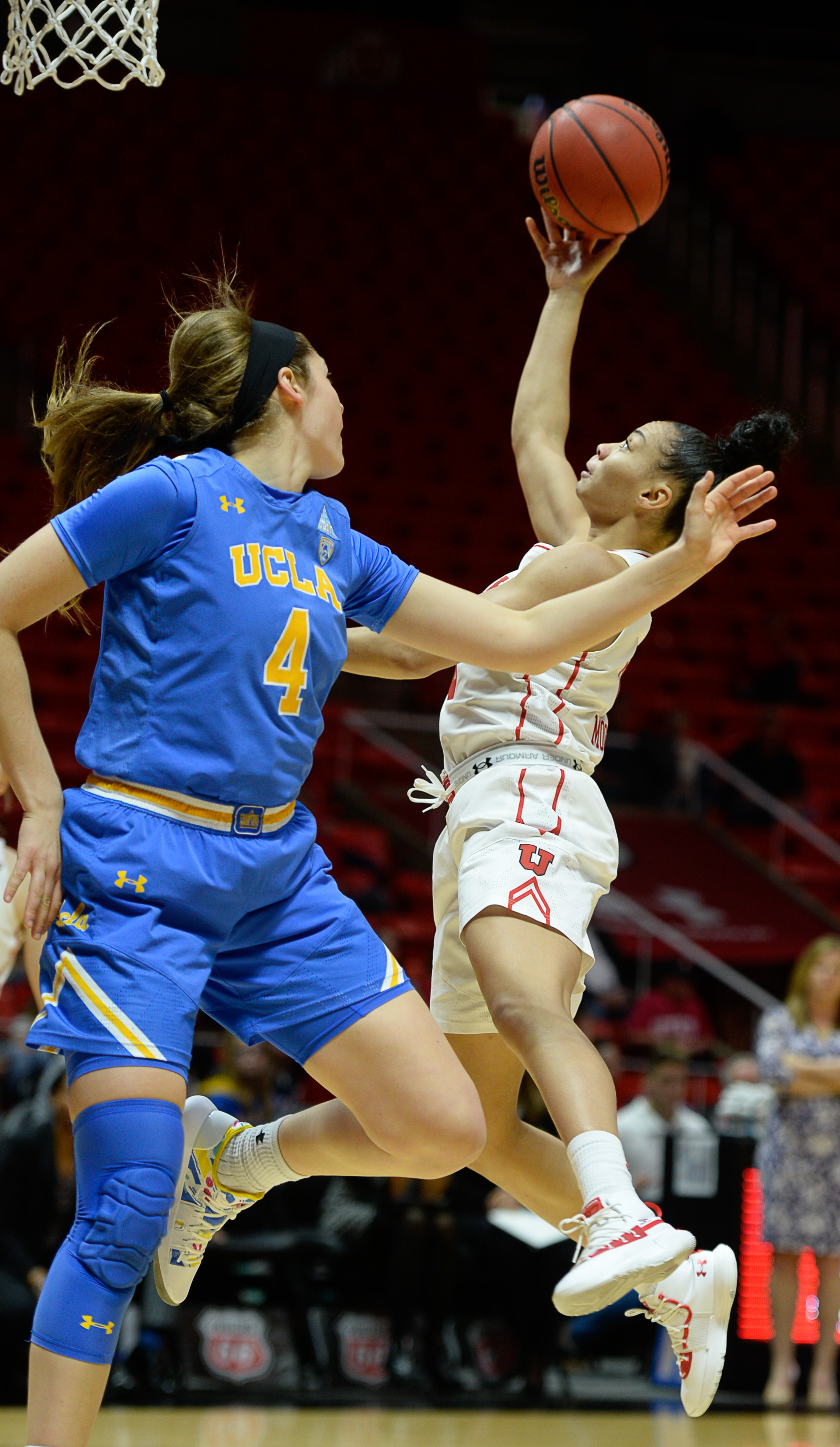 (Francisco Kjolseth | The Salt Lake Tribune) Utah Utes guard Kiana Moore (0) slips past UCLA Bruins guard Lindsey Corsaro (4) at the Jon M. Huntsman Center in Salt Lake City on Sunday, Feb. 10, 2019.