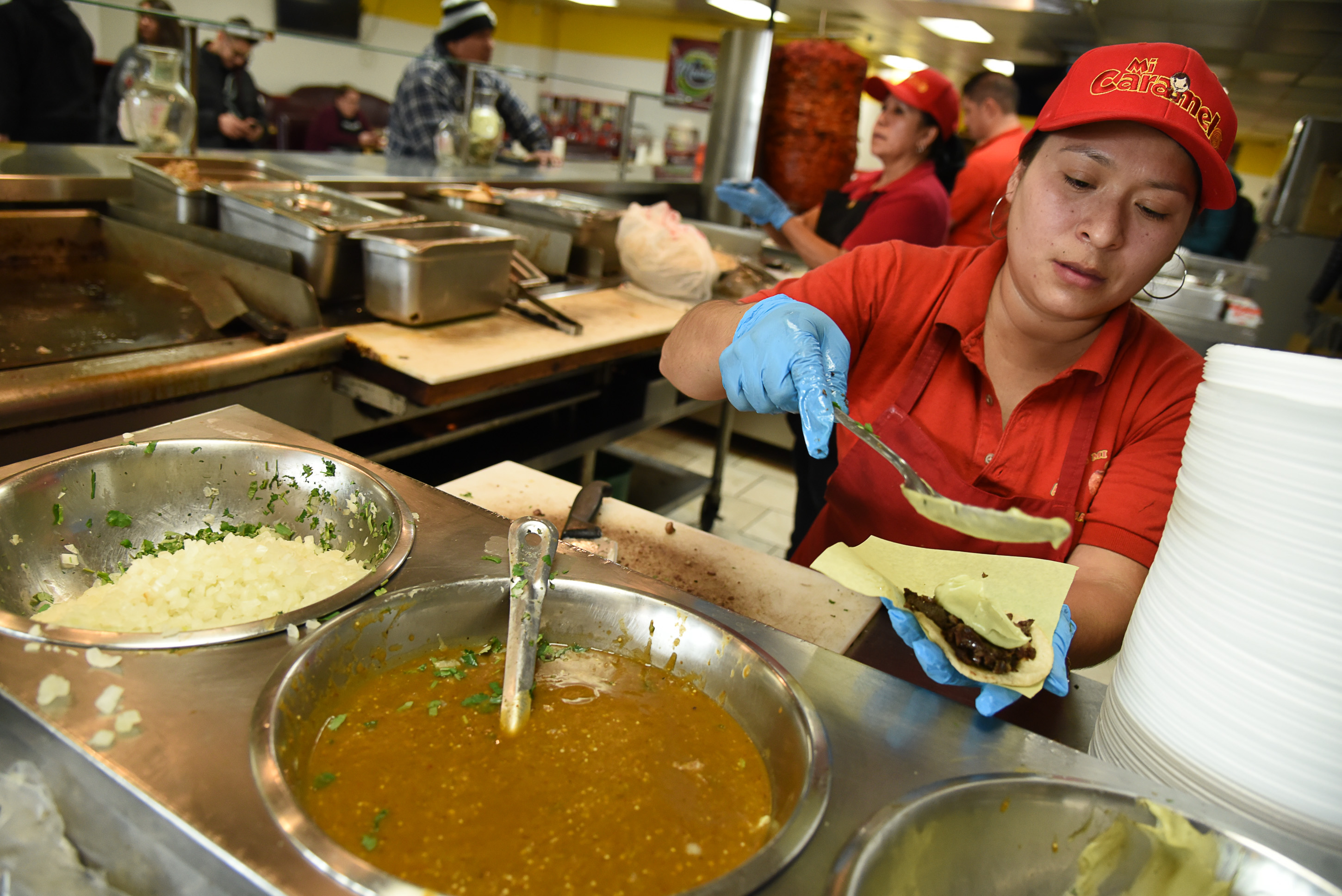 (Francisco Kjolseth | The Salt Lake Tribune) Hilda Vargas assembles aside and tripa tacos for a customer at Tacos Mi Caramelo, a late-night taqueria that is open until 2 a.m. most nights and 24-hours a day on Friday and Saturday.