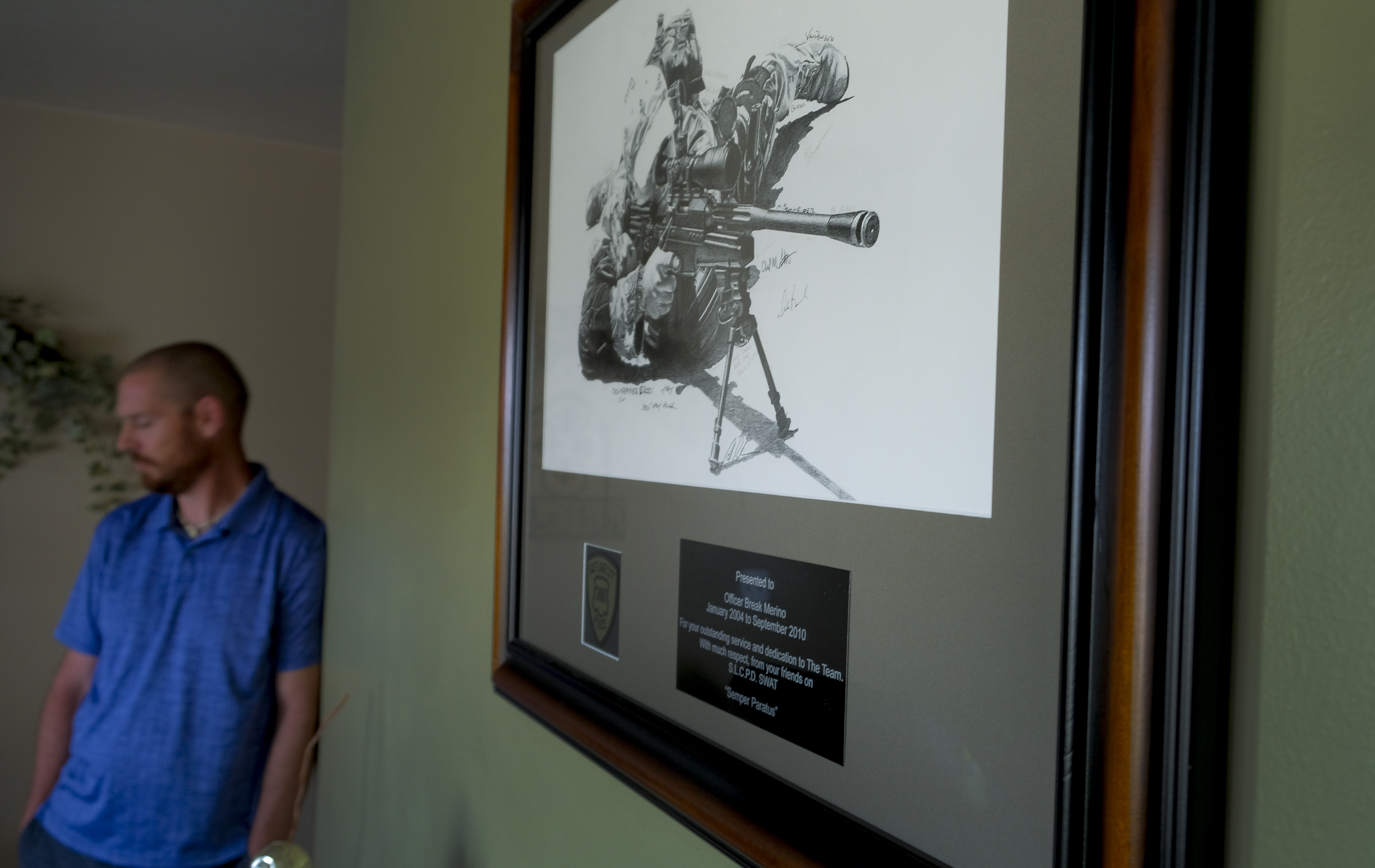 ( Leah Hogsten | The Salt Lake Tribune ) Break Merino stands near a sketch of himself from the Salt Lake City Police Department thanking him for his "outstanding service and dedication to The Team" from January 2004 to September 2010 on the SWAT unit. Merino was terminated after taking leave for post-traumatic stress disorder, including a PTSD-related condition where cortisol builds up behind his retinas, causing vision impairment in his left eye.