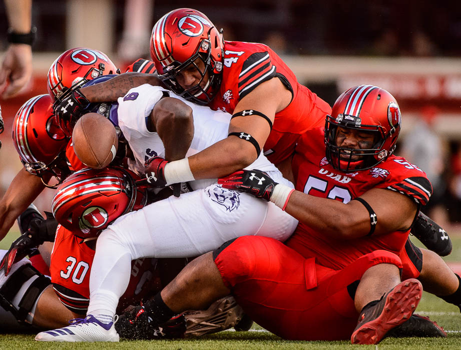 (Trent Nelson | The Salt Lake Tribune) Utah defenders swarm on Weber State Wildcats running back Treshawn Garrett (6), who loses the ball as the University of Utah Utes host the Weber State Wildcats, Thursday Aug. 30, 2018 at Rice-Eccles Stadium in Salt Lake City.