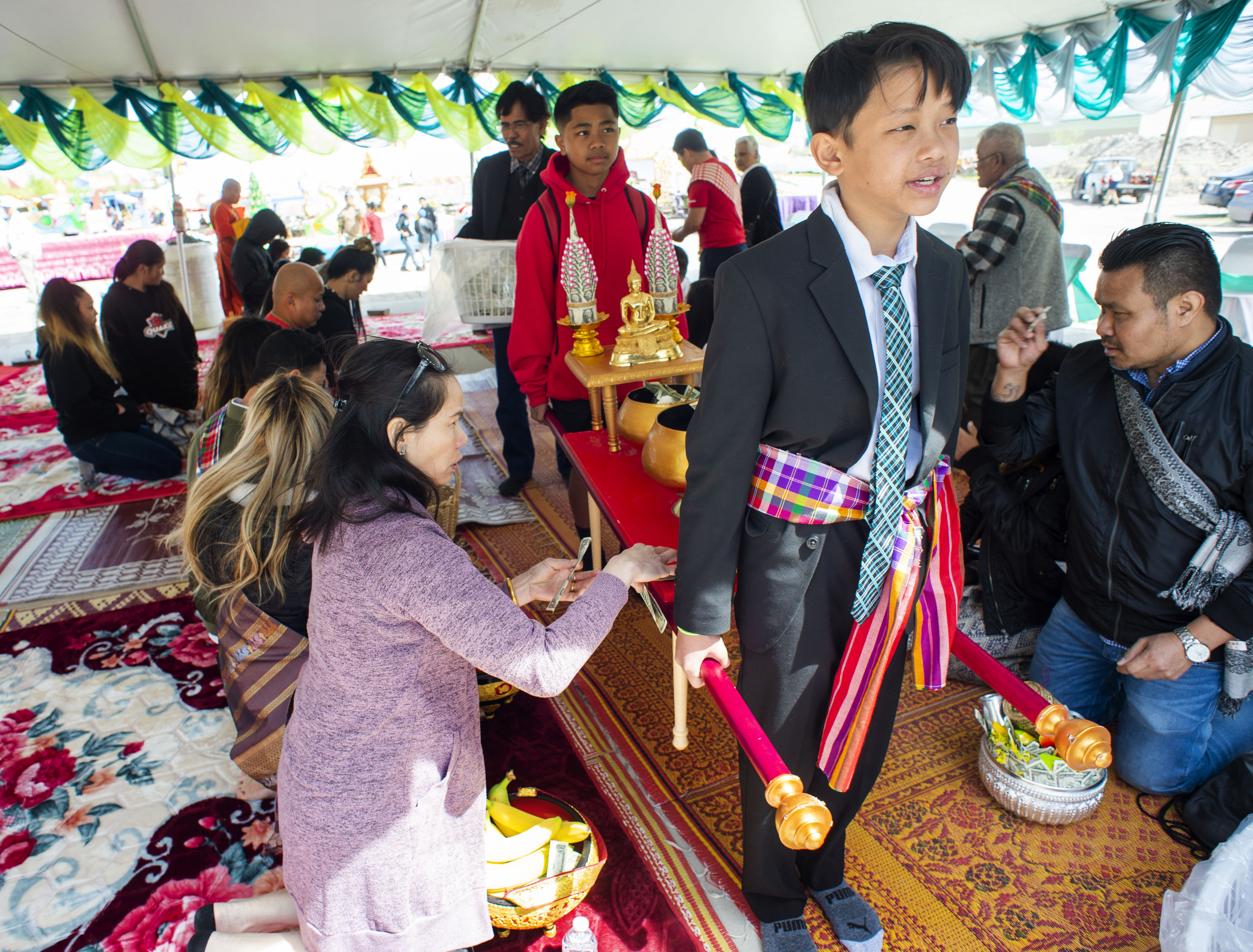 (Rick Egan | The Salt Lake Tribune) AJ Bhanthamisay leads the procession during the Bak Baht, at the Wat Lao Salt Lake Buddharam Utah, New Year Celebration, in West Valley City, Sunday, April 28, 2019. 