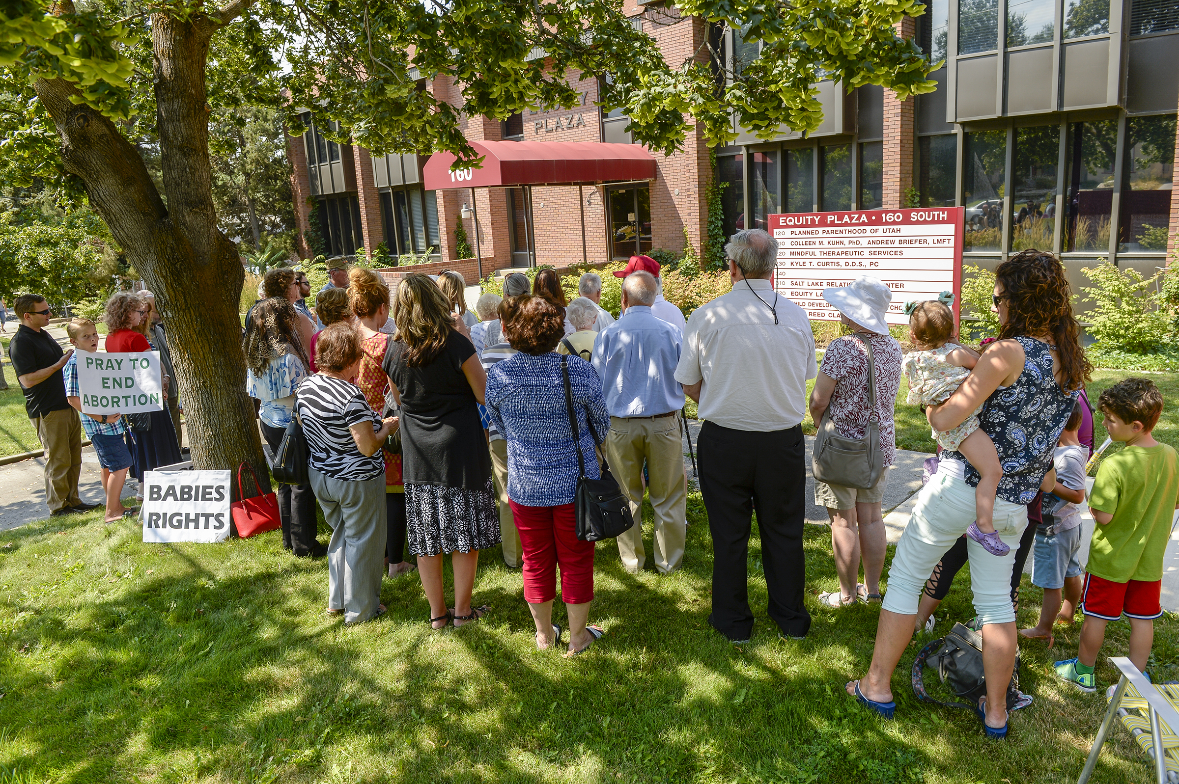Leah Hogsten | The Salt Lake Tribune Catholic priest, Rev. Jan Bednarz of St. Martin de Porres Parish in Taylorsville, leads the "blessed sacrament" and exorcism at the Planned Parenthood offices on the Feast of the Assumption. Bednarz was joined by the group, "40 Days for Life Utah," to protest Planned Parenthood.