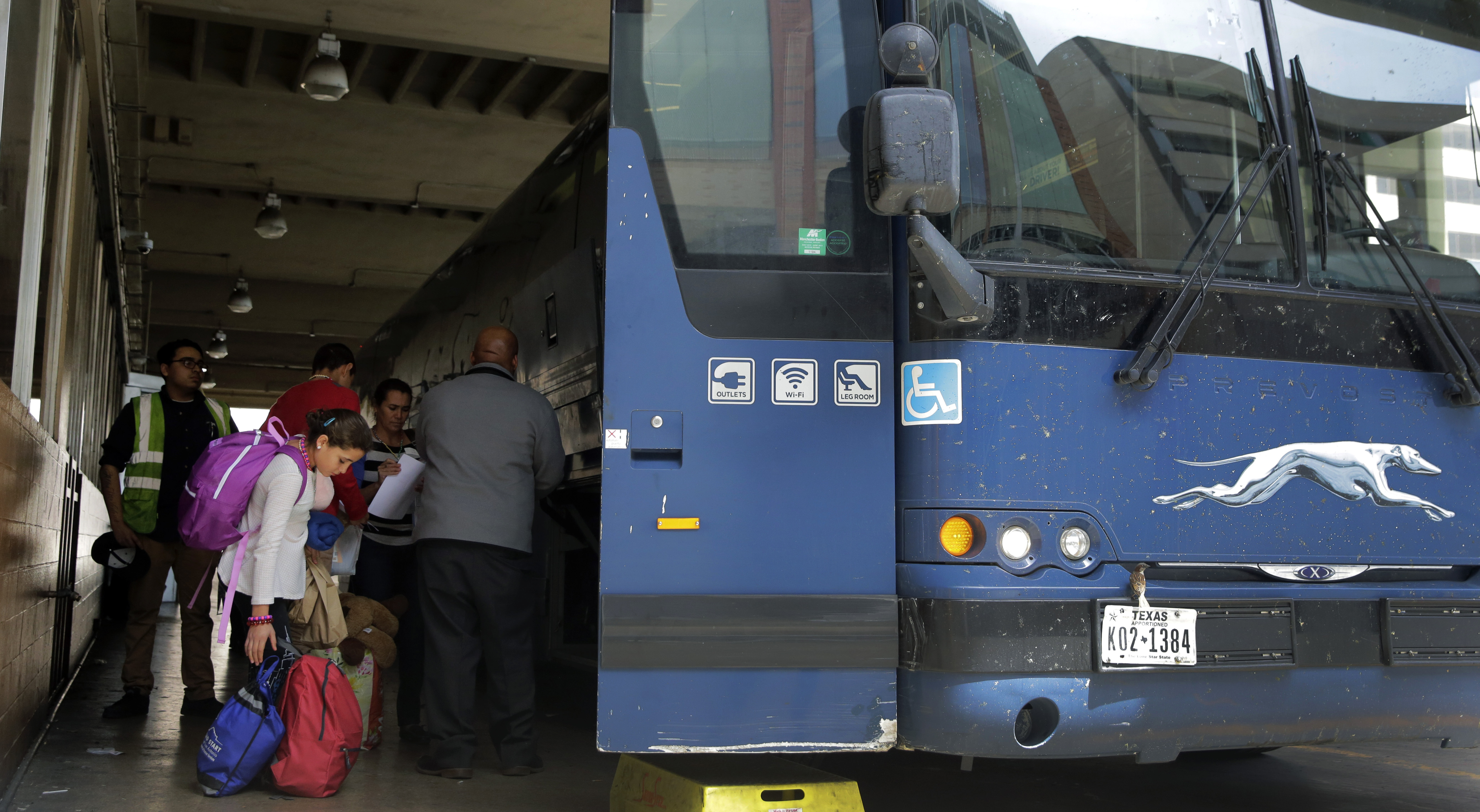 Immigrants from Central America seeking asylum board a bus, Tuesday, April 2, 2019, in downtown San Antonio. The surge of migrants arriving at the southern border has led the Trump administration to dramatically expand a practice it has long mocked as "catch and release." (AP Photo/Eric Gay)