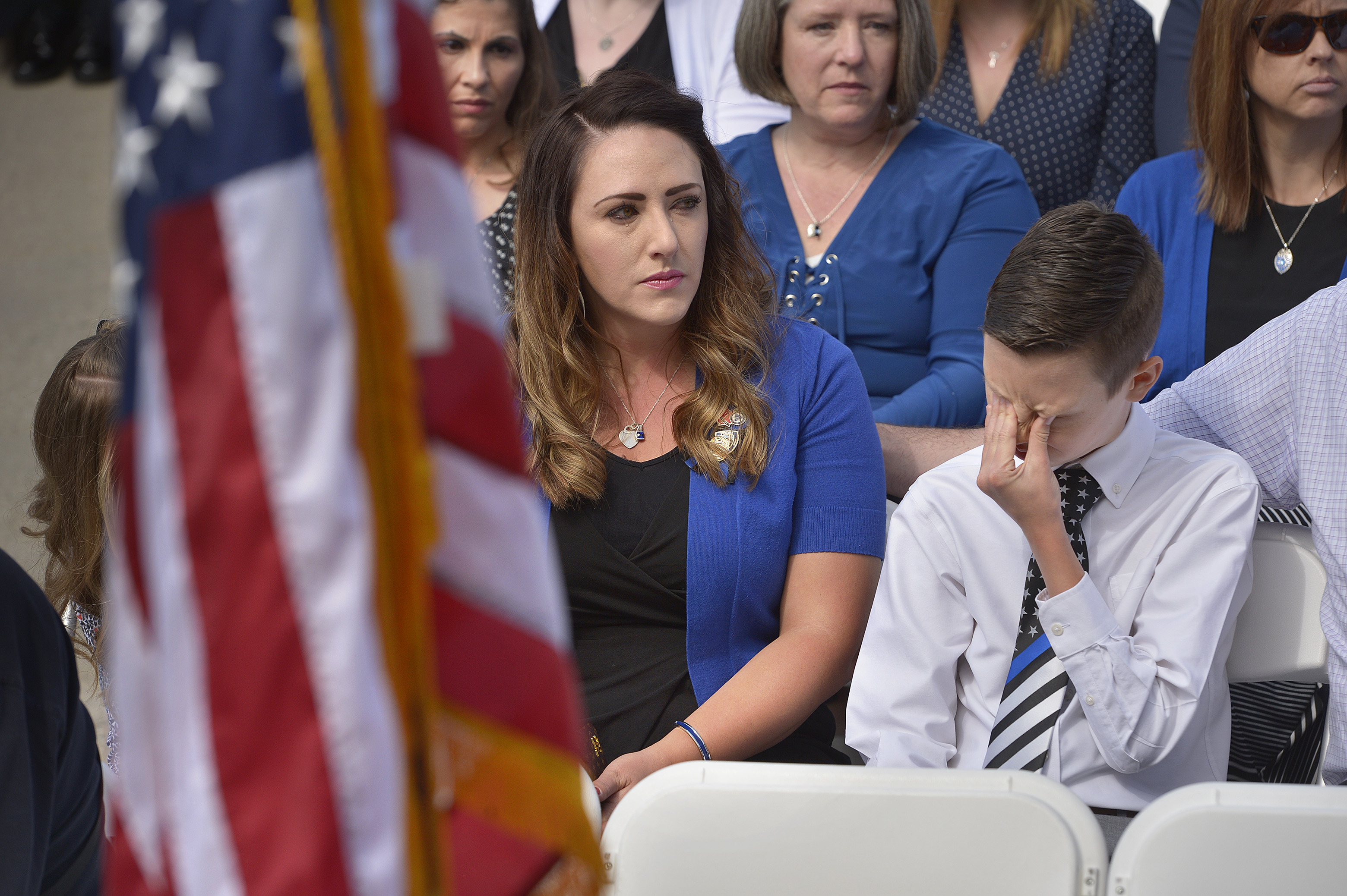 (Scott Sommerdorf | The Salt Lake Tribune) Draper police Sgt. Derek Johnson's widow Shante Johnson sat with stepson Cayden Stone as they listened to Garon Brett sing "Why" at the Utah Law Enforcement Memorial, Thursday, May 3, 2018. No Utah law enforcement officer died in the line of duty last year.