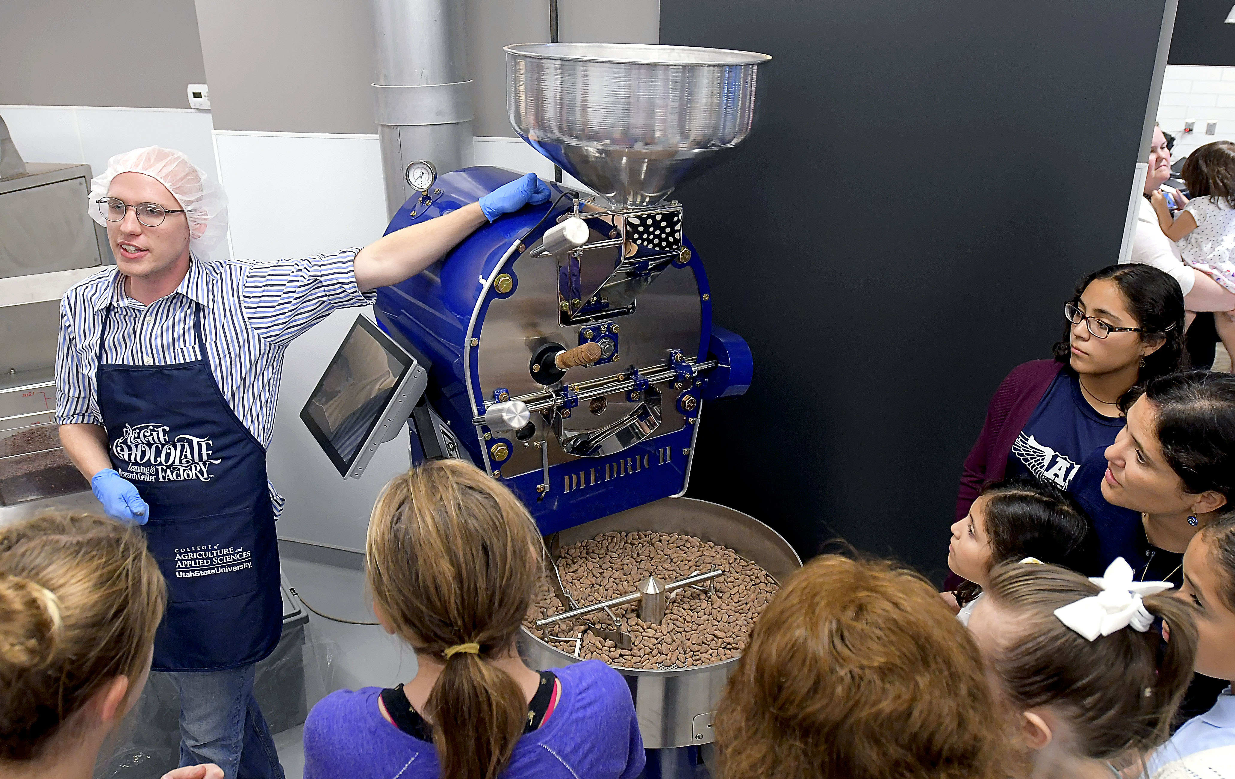 (Eli Lucero | The Herald Journal) Zachary Cooper talks about how they roast cocoa beans during a public tour of the Aggie Chocolate Factory on Tuesday in Logan.