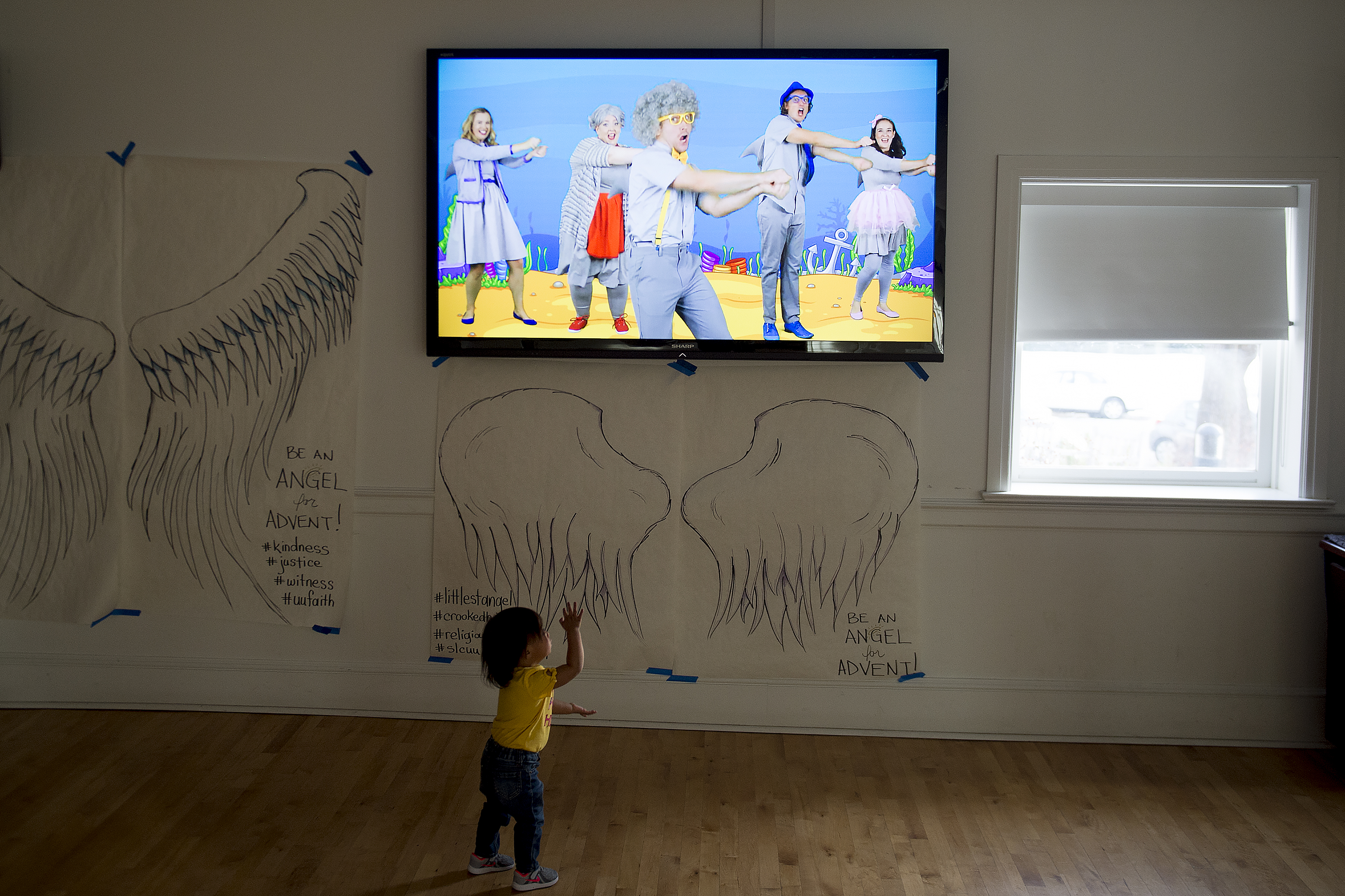(Jeremy Harmon | The Salt Lake Tribune) Seventeen-month-old Bella dances along with a "baby shark" video as she plays inside the First Unitarian Church on 1300 East in Salt Lake City on Dec. 14, 2018.