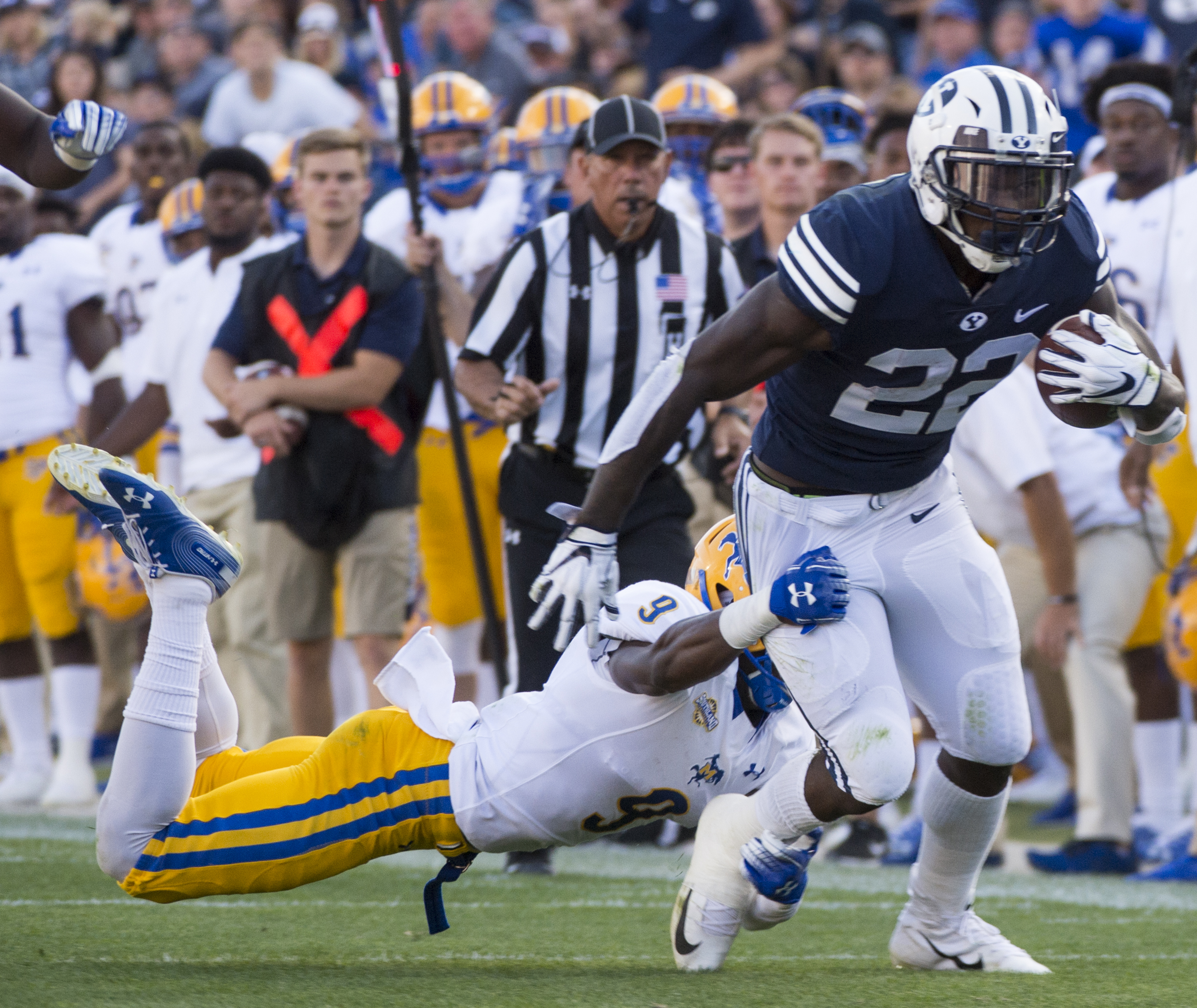 (Rick Egan | The Salt Lake Tribune) Brigham Young Cougars running back Squally Canada (22) gets past McNeese State Cowboys defensive lineman Cody Roscoe (57) and McNeese State Cowboys defensive back Trent Jackson (9), in football action Brigham Young Cougars vs McNeese State Cowboys at Lavell Edwards Stadium, Saturday, Sept. 22, 2018. 