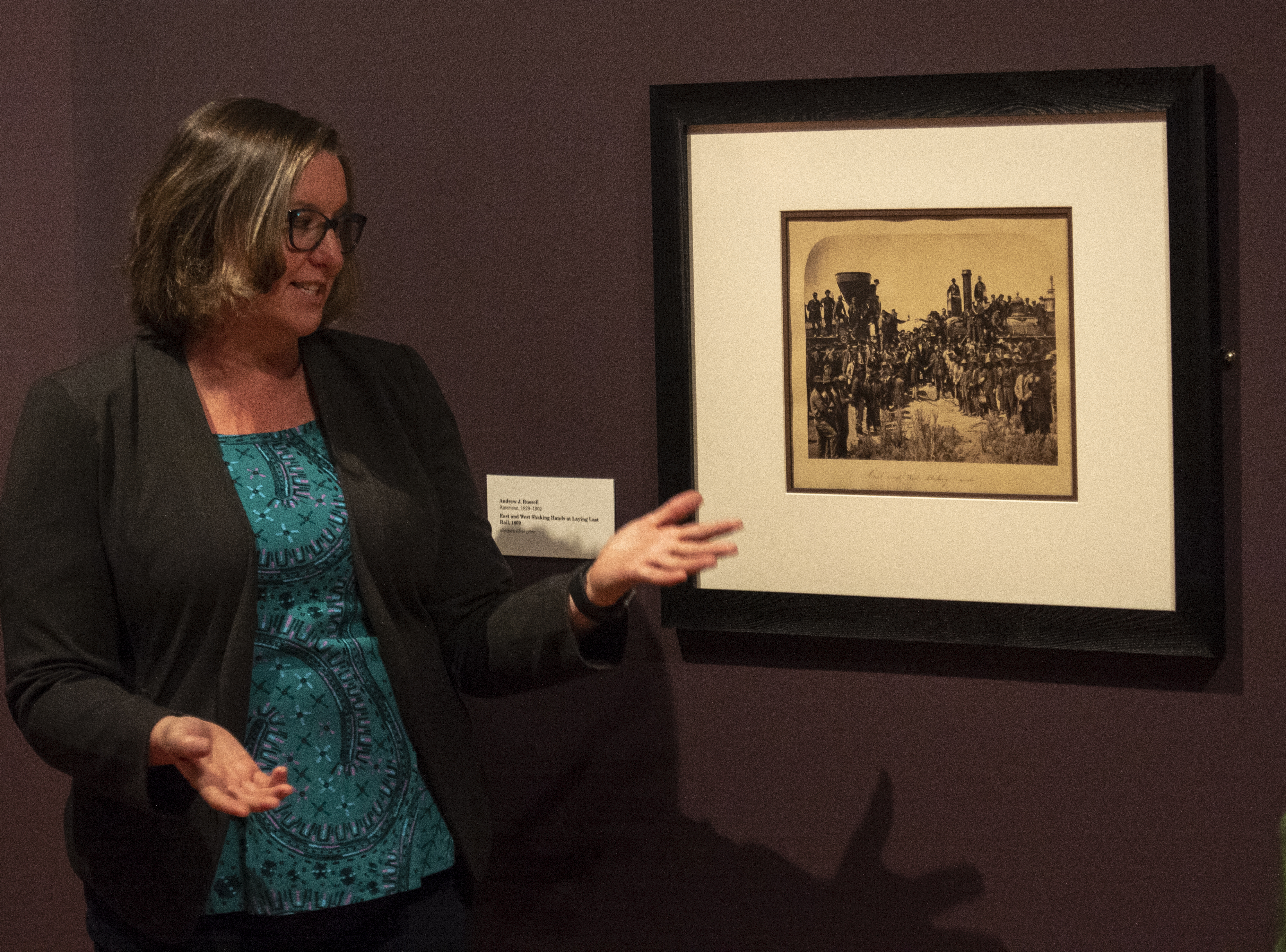 (Rick Egan | The Salt Lake Tribune) Paricia Labounty, curator of the Union Pacific Railroad Museum in Council Bluffs, IA, talks about the photo by Andrew J. Russell, of the East and West Shaking Hands at Laying Last Rail during a media tour of the new exhibit, at the Utah Museum of Fine Arts. Thursday, Jan. 31, 2019. 