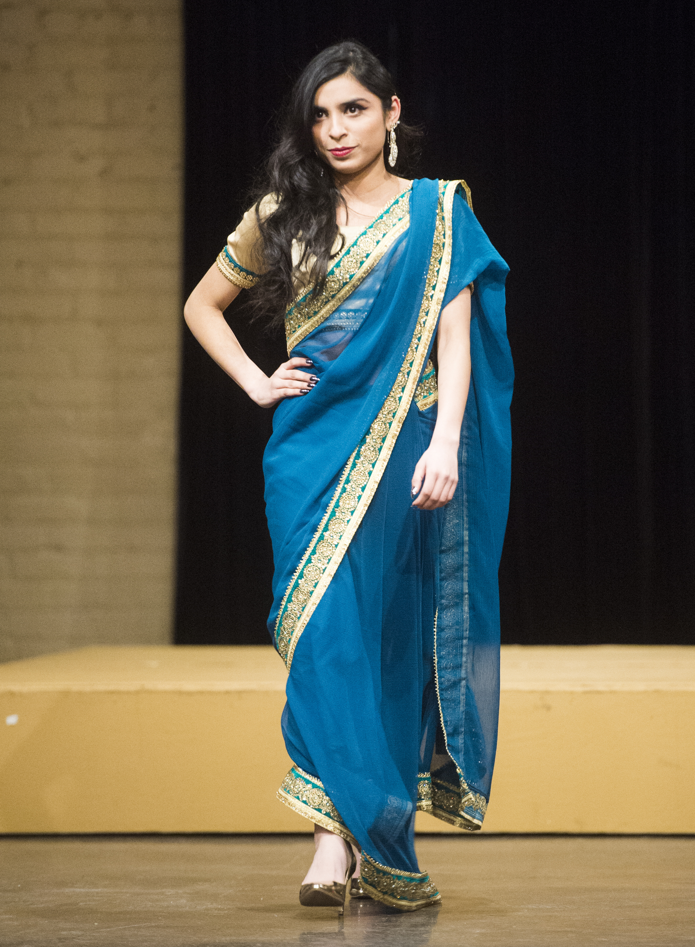 (Rick Egan | The Salt Lake Tribune) Mesha models a dress from Pakistan at the 8th Annual Women of the World Fashion Show. The fashion show fund is raiser for the non-profit that seeks to help refugees settle in a new culture. Wednesday, March 7, 2018. 