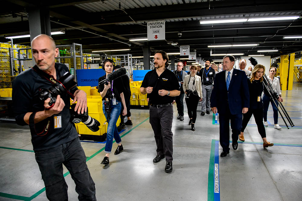 (Trent Nelson | The Salt Lake Tribune) General Manager Mike Taylor leads Utah Governor Gary Herbert on a tour of Amazon's fulfillment center in Salt Lake City on Wednesday April 17, 2019.