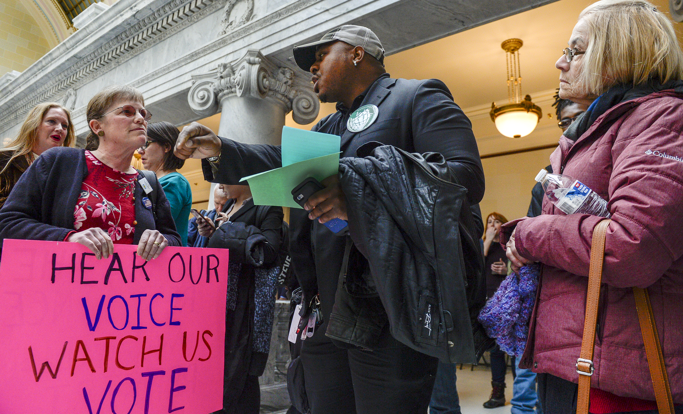 Leah Hogsten | The Salt Lake Tribune l-r Ellie Brownstein, who is in opposition to SB96 and Wiz Rouzard with Americans for Prosperity in favor of SB96 debate for and against in front of the Utah House chamber, Feb. 8, 2019. 