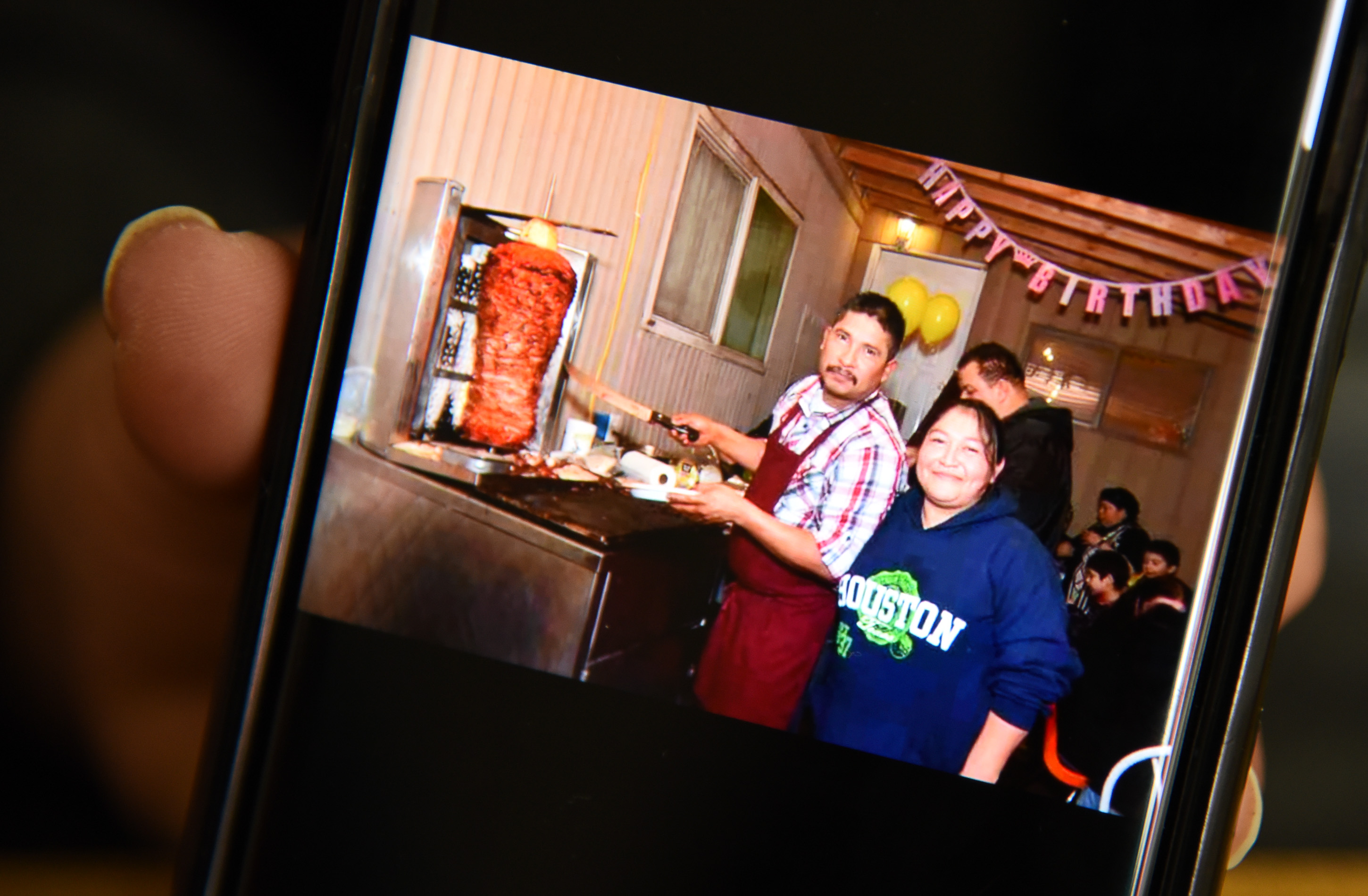 (Francisco Kjolseth | The Salt Lake Tribune) Carolina Marquez shows off photos on her phone of her late husband Adrian De Los Santos Luna when they were first starting out selling tacos outside of their home in West Valley City. 