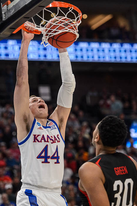 (Trent Nelson | The Salt Lake Tribune) Kansas Jayhawks forward Mitch Lightfoot (44) dunks over Northeastern Huskies center Anthony Green (30) as Kansas faces Northeastern in the 2019 NCAA Tournament in Salt Lake City on Thursday March 21, 2019.