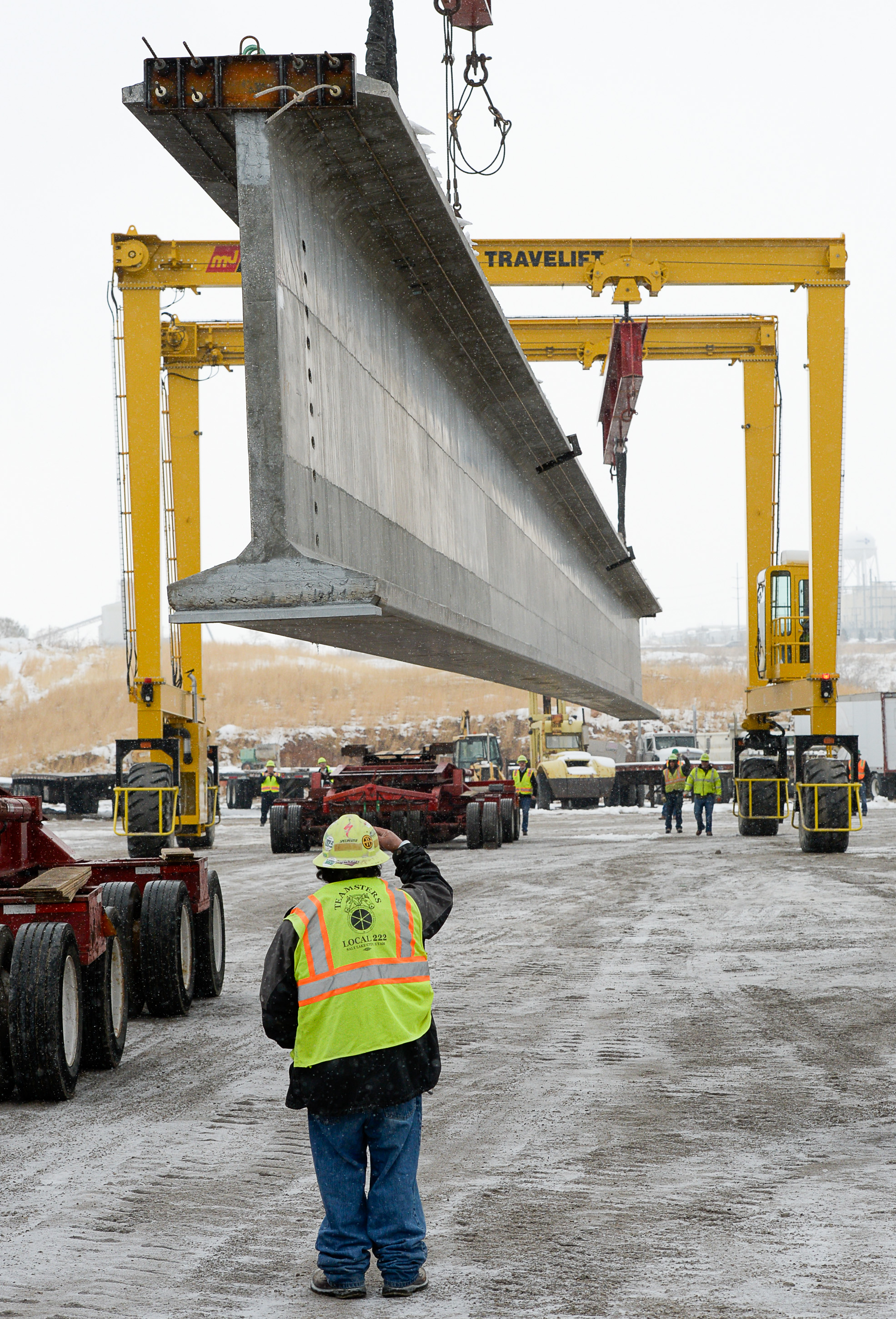 (Francisco Kjolseth | The Salt Lake Tribune) UDOT gets ready to place some of the world's largest-ever bridge beams, and the largest in Utah state history with a span of 203 ft long and just over 8 ft tall, as crews load one on a truck following manufacturing at Forterra Structural Precast in Kearns on Tuesday, Dec. 11, 2018. A total of six beams will be installed in the technology corridor in Lehi later this week.
