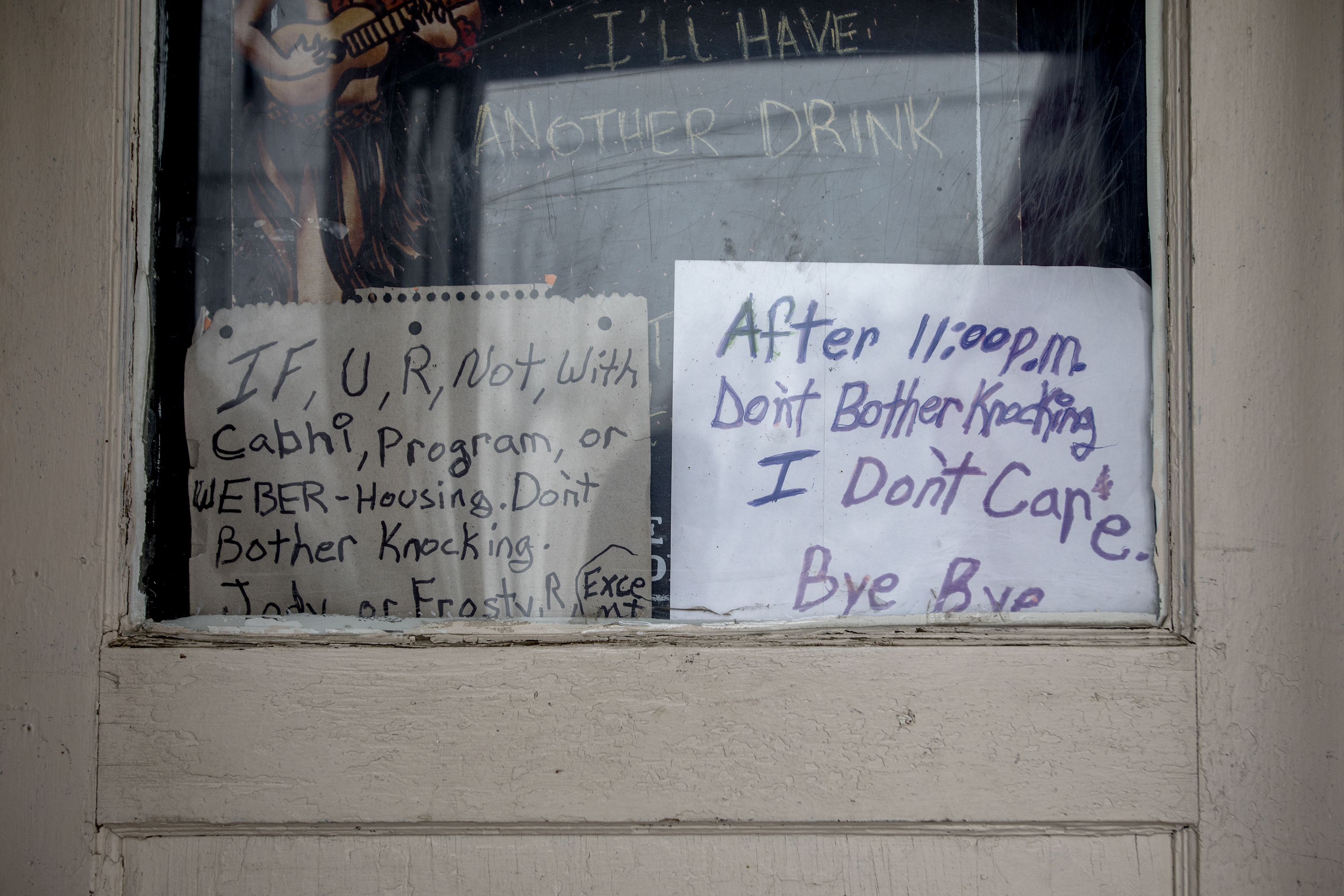 Homemade signs cover Doug "Boy Scout" Harding's front door at his West Ogden home on Feb. 19, 2018. Since moving into housing, Harding has fluctuated between staying close with the homeless community that he knows well and trying to break away from the same people that he feels are taking advantage of his situation. (Benjamin Zack/Standard-Examiner via AP)