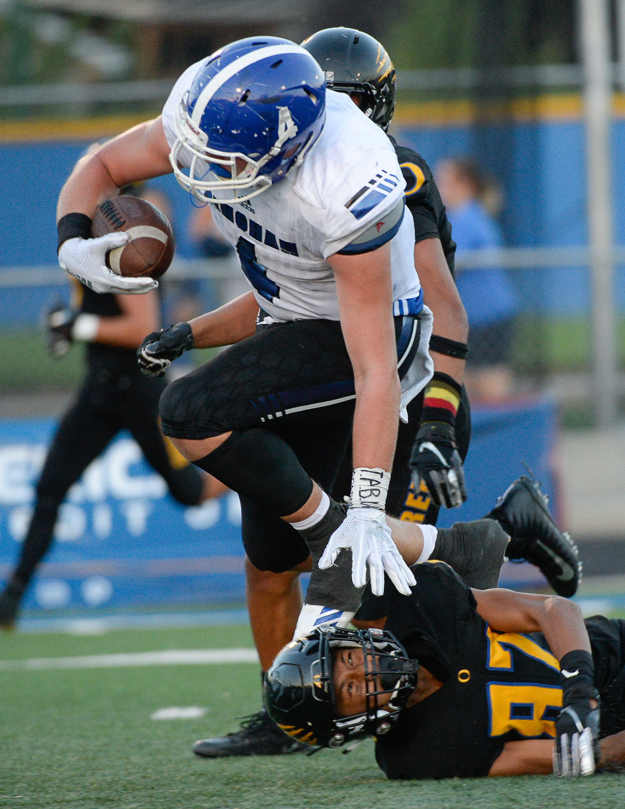 (Francisco Kjolseth | The Salt Lake Tribune) Bingham's Briasen Harward runs over Orem's Jakob Robinson as he nears the end zone, Thursday, Aug. 16, 2018 in Orem.