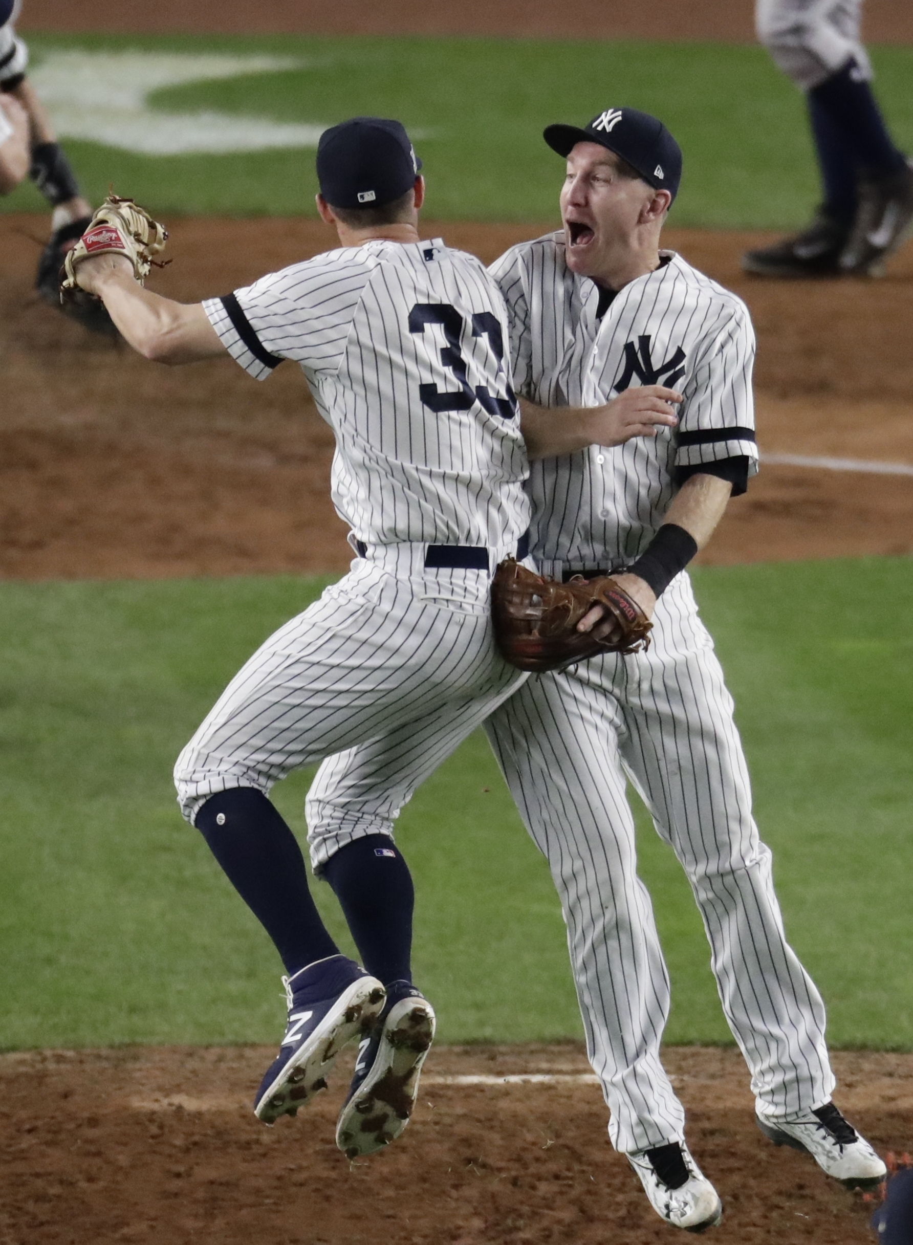 New York Yankees' Didi Gregorius and Starlin Castro celebrate after Game 5 of baseball's American League Championship Series against the Houston Astros Wednesday, Oct. 18, 2017, in New York. The Yankees won 5-0 to take a 3-2 lead in the series. (AP Photo/Frank Franklin II)