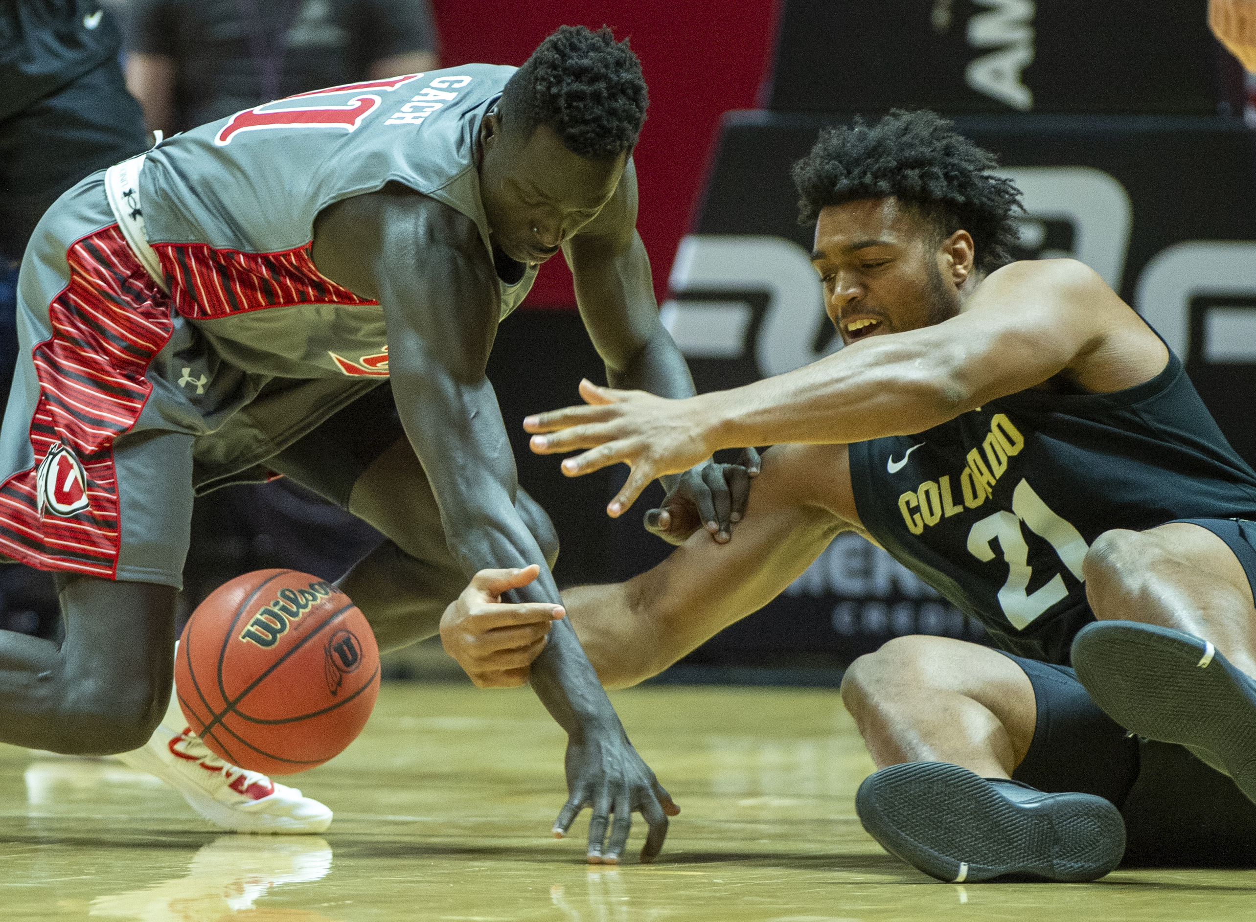 (Rick Egan | The Salt Lake Tribune) Utah Utes forward Both Gach (11) goes for a loose ball along with Colorado Buffaloes forward Evan Battey (21), in PAC-12 basketball action between the Utah Utes and the Colorado Buffaloes at the Jon M. Huntsman Center, Sunday, Jan. 20, 2019. 