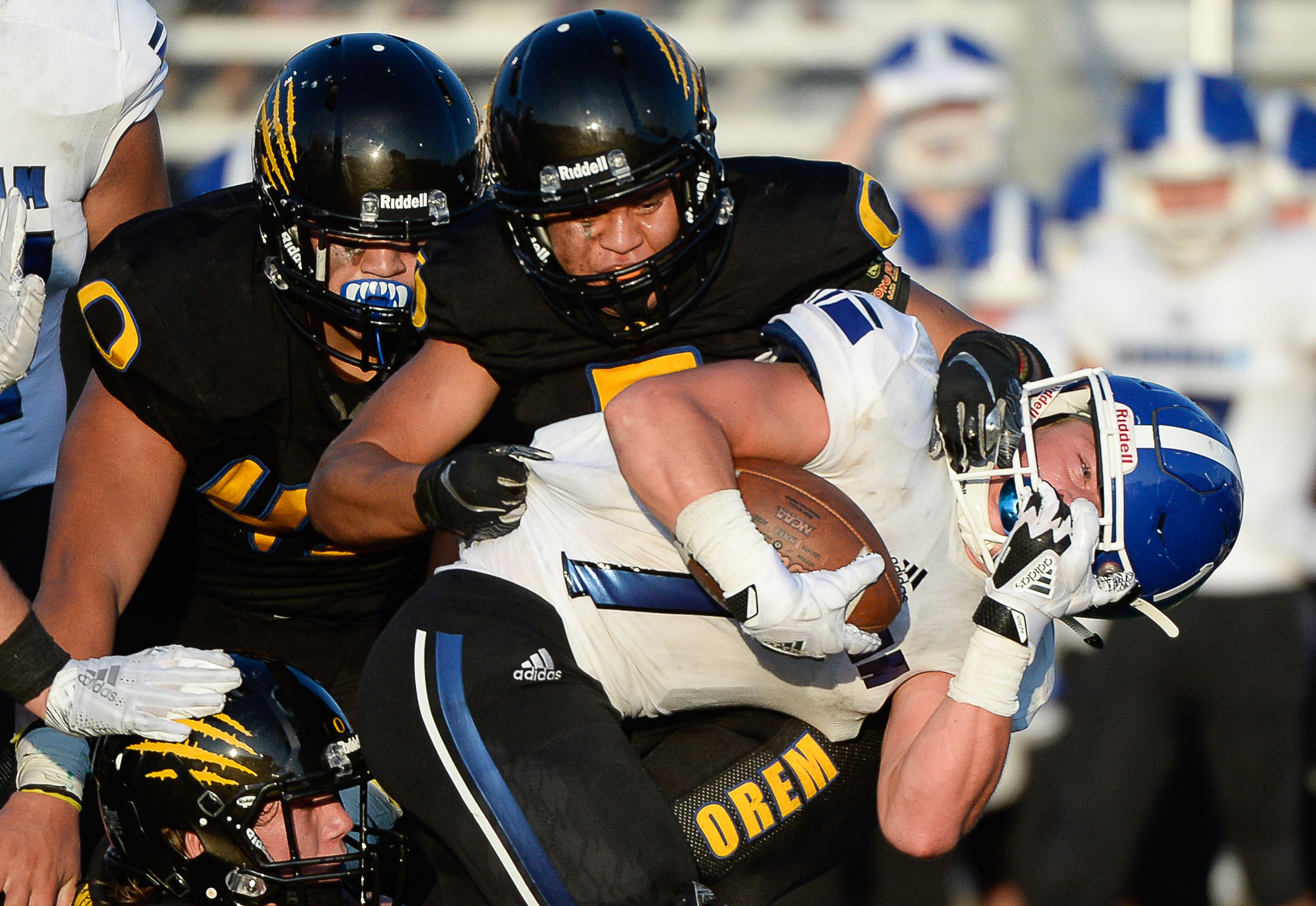 (Francisco Kjolseth | The Salt Lake Tribune) Bingham's Braedon Wissler has his helmet twisted as the Orem defense roughs him up in Orem, Thursday, Aug. 16, 2018.