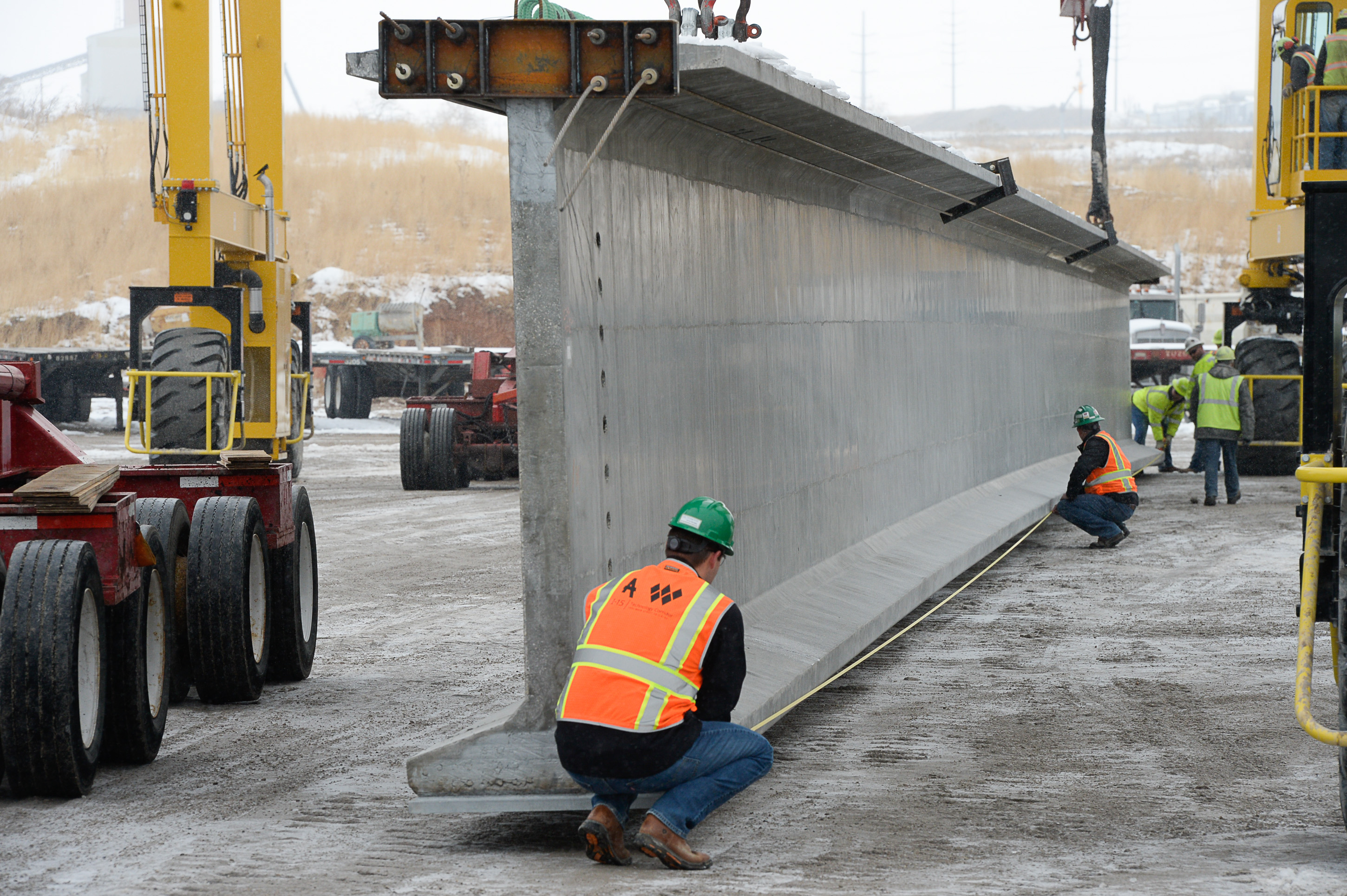(Francisco Kjolseth | The Salt Lake Tribune) UDOT gets ready to place some of the world's largest-ever bridge beams, and the largest in Utah state history with a span of 203 ft long and just over 8 ft tall, as crews load one on a truck following manufacturing at Forterra Structural Precast in Kearns on Tuesday, Dec. 11, 2018. A total of six beams will be installed in the technology corridor in Lehi later this week.