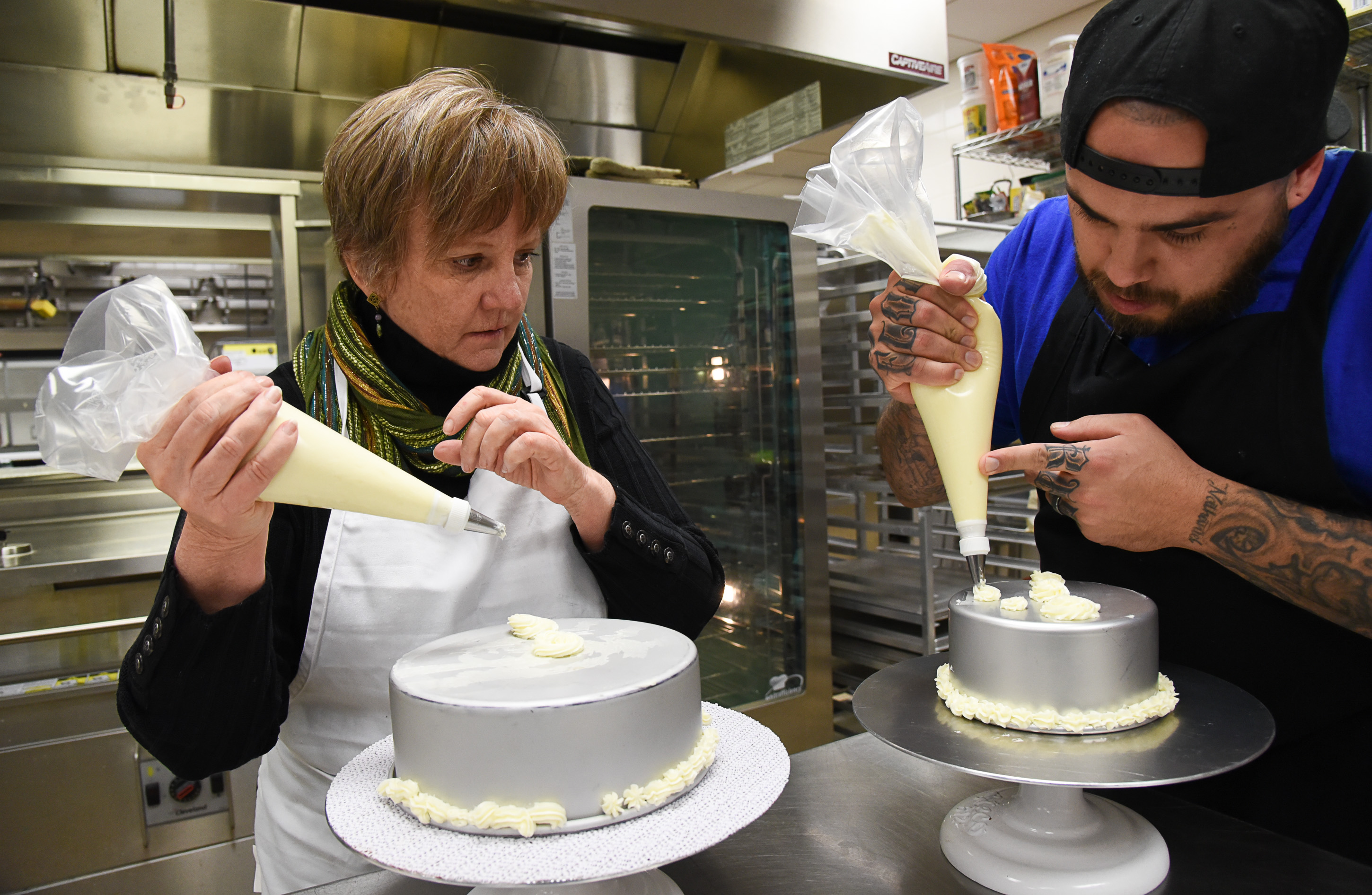 (Francisco Kjolseth | The Salt Lake Tribune) Actress Betsy West gets a little guidance with frosting a cake from chef A.J. Collette as she prepares for an upcoming role of a Southern Baptist bakery owner in North Carolina faced with a request to bake a cake for a gay couple getting married for Salt Lake Acting Company's production of "The Cake." A self admitted baking novice, West, in search of better authenticity in portraying her role received a one-on-one lesson from the chef's at Flourish.