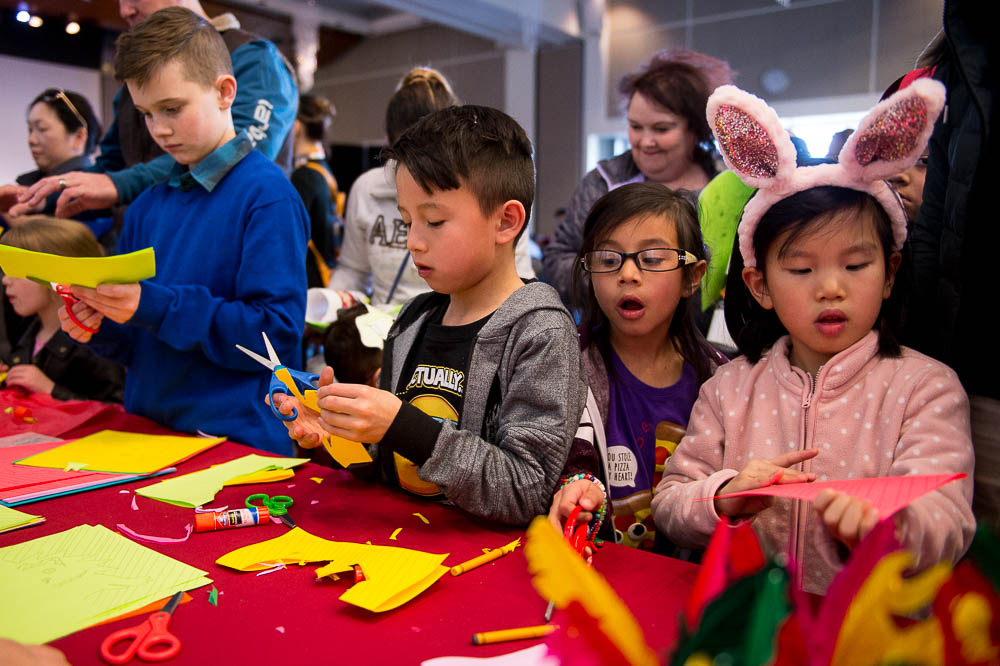 (Trent Nelson | The Salt Lake Tribune) Children work on origami at the Chinese New Year Celebration at the County Library's Viridian Event Center in West Jordan, Saturday Feb. 17, 2018.