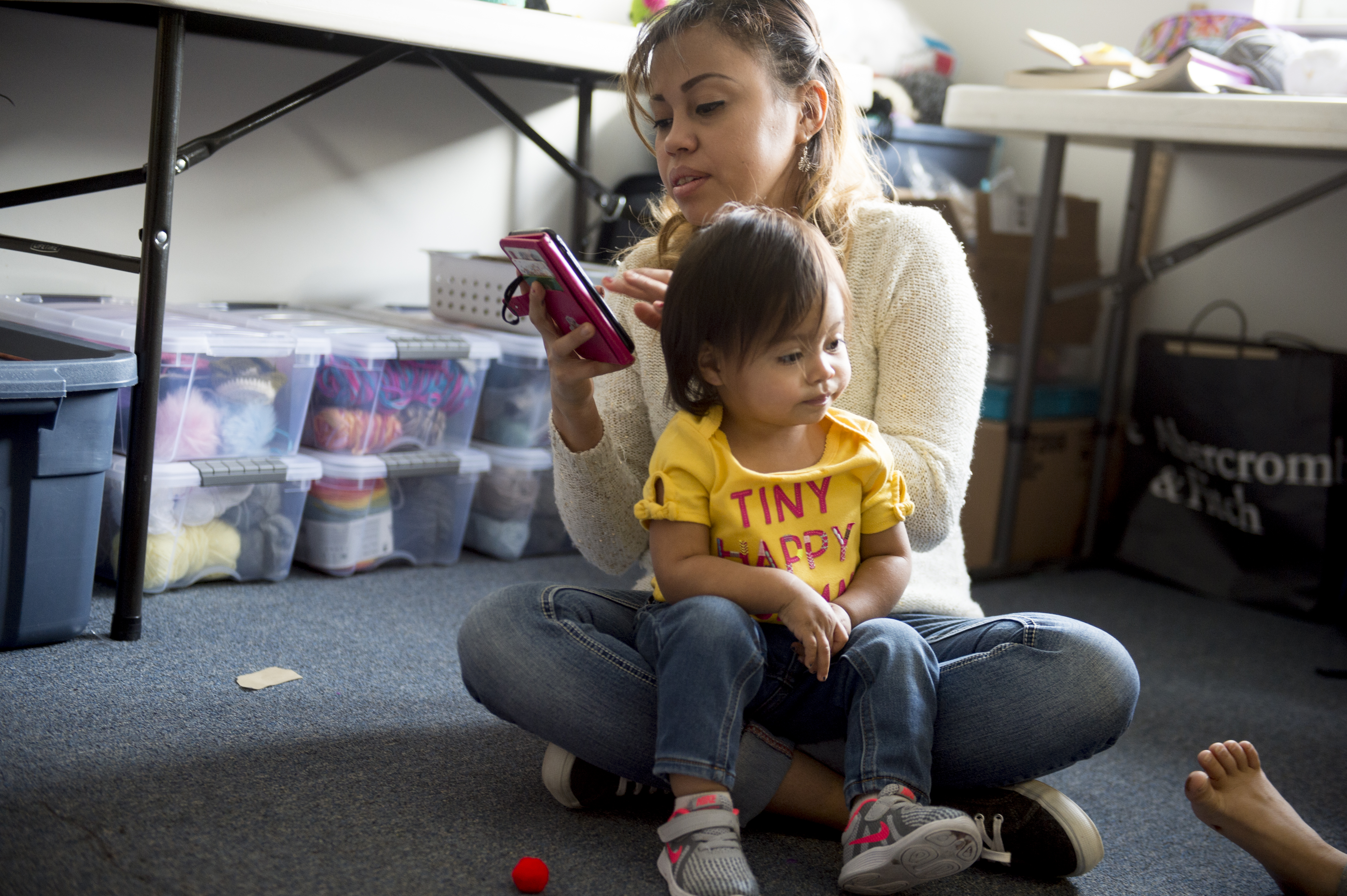 (Jeremy Harmon | The Salt Lake Tribune) Vicky Chavez replies to a text from a family member as she looks after her daughters, 17-month-old Bella and 7-year-old Yaretzi, in their room at the First Unitarian Church on 1300 East in Salt Lake City on Dec. 14, 2018.