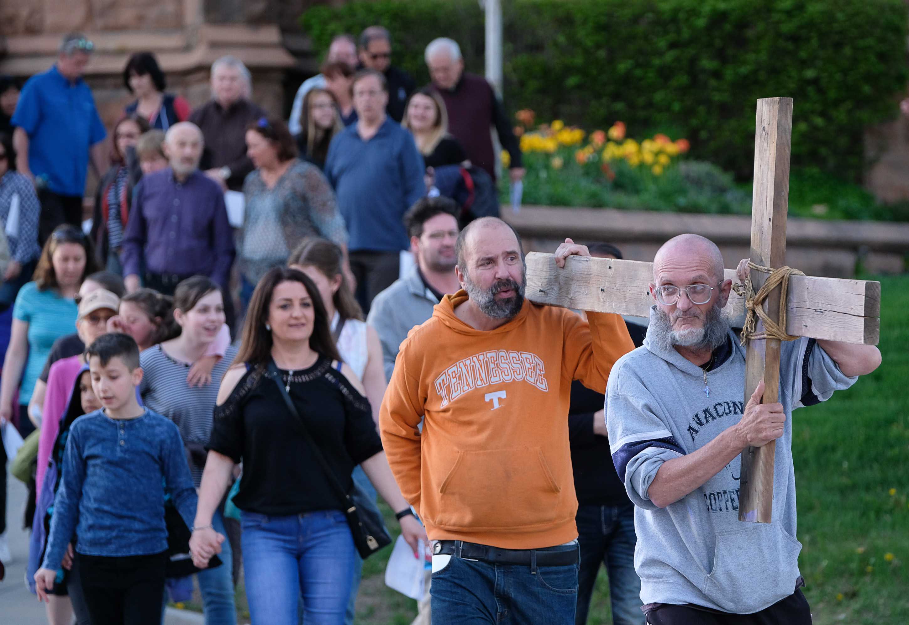 (Francisco Kjolseth | The Salt Lake Tribune) Alex Bury, right, and Kent Kilburn take a turn carrying the cross as christians march through streets of Salt Lake City on Good Friday to symbolically mark Jesus' carrying the cross to his crucifixion beginning at Cathedral of the Madeleine.