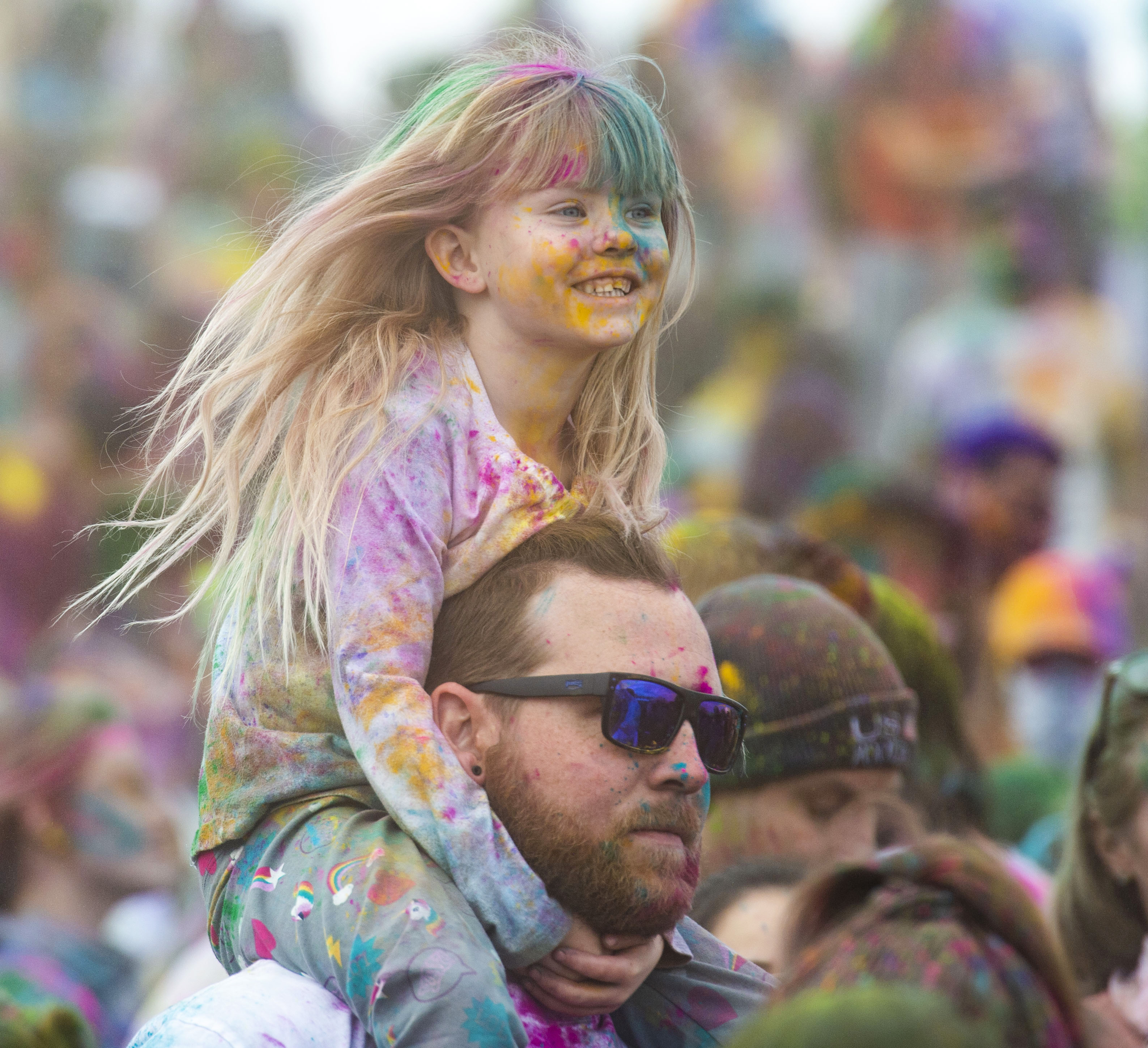 (Rick Egan | The Salt Lake Tribune) Jaycee, 4, gets a good view of the festivities from her dad Parker Haworth's shoulders, at the Holi Festival of Colors celebration at the Sri Sri Radha Krishna Temple in Spanish Fork, Saturday, March 30, 2019. 